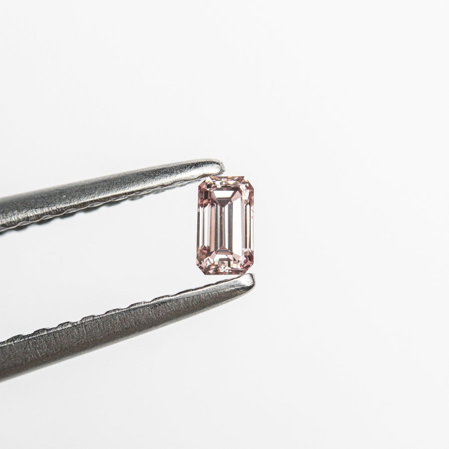 The 0.12ct 3.42x1.96x1.76mm VS1 Fancy Intense Orangy Pink Cut Corner Rectangle Step Cut 24108-01 by East London jeweller Rachel Boston | Discover our collections of unique and timeless engagement rings, wedding rings, and modern fine jewellery. - Rachel Boston Jewellery