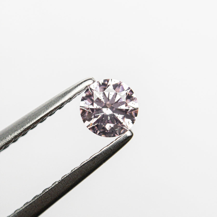 The 0.28ct 4.28x4.25x2.56mm GIA I1 Fancy Purplish Pink Round Brilliant 24167-01 by East London jeweller Rachel Boston | Discover our collections of unique and timeless engagement rings, wedding rings, and modern fine jewellery. - Rachel Boston Jewellery