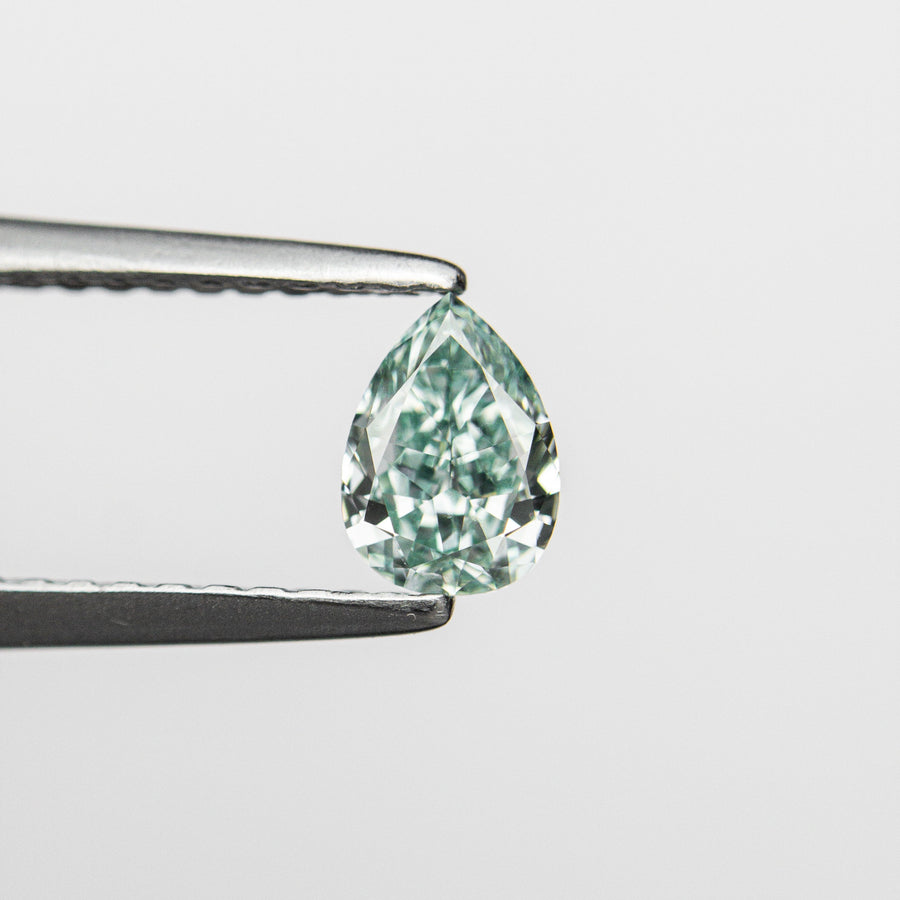 The 0.32ct 5.48x3.95x2.17mm GIA Fancy Vivid Bluish Green Pear Brilliant 24131-01 by East London jeweller Rachel Boston | Discover our collections of unique and timeless engagement rings, wedding rings, and modern fine jewellery. - Rachel Boston Jewellery