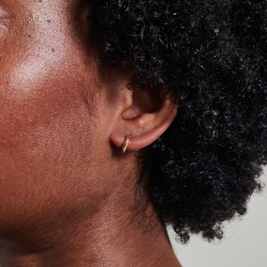 The 10mm Knife Edge Huggie Hoop Earrings by East London jeweller Rachel Boston | Discover our collections of unique and timeless engagement rings, wedding rings, and modern fine jewellery. - Rachel Boston Jewellery