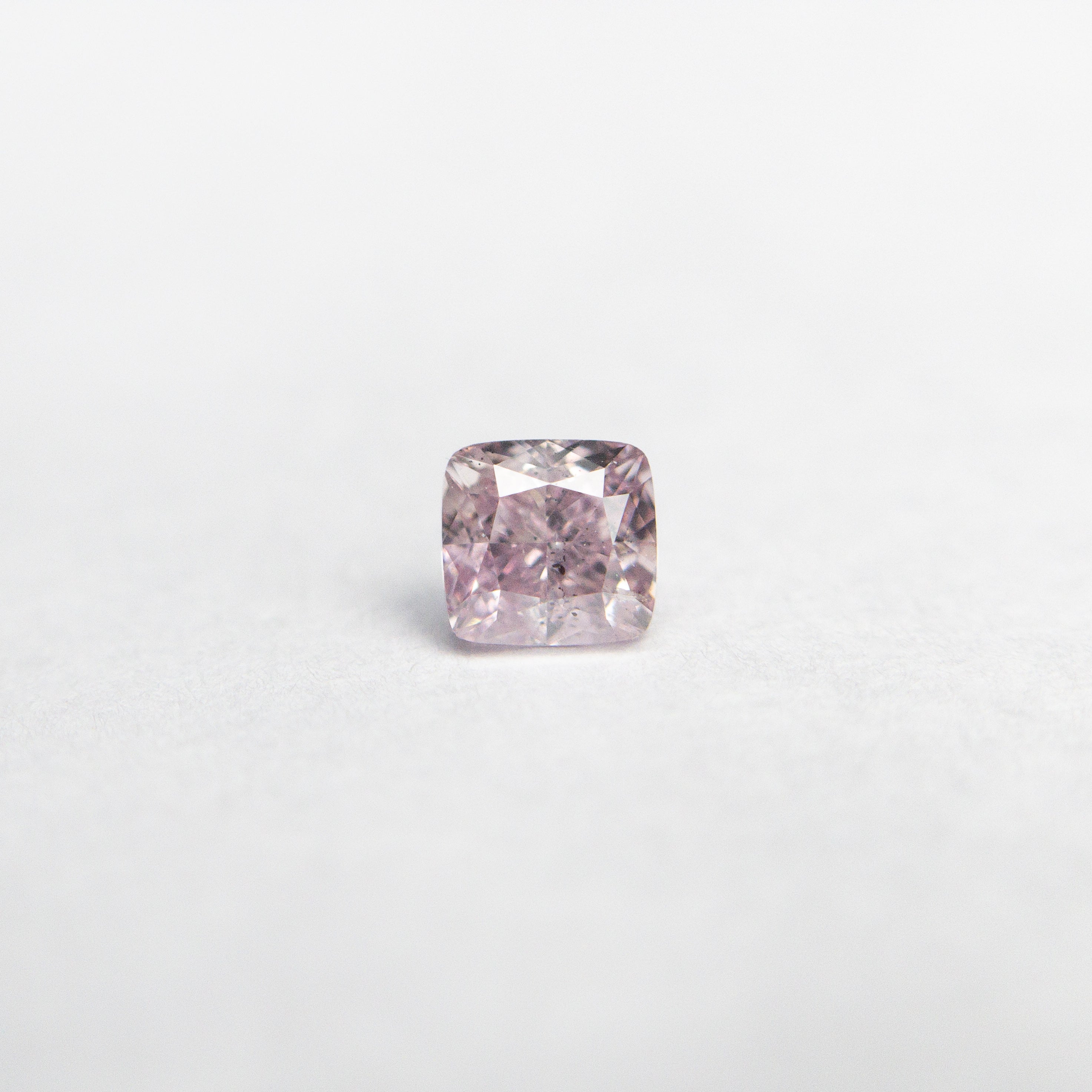 The 0.20ct 3.16x3.01x2.15mm GIA SI2 Fancy Purple-Pink Cushion Brilliant 🇦🇺 24098-01 by East London jeweller Rachel Boston | Discover our collections of unique and timeless engagement rings, wedding rings, and modern fine jewellery.
