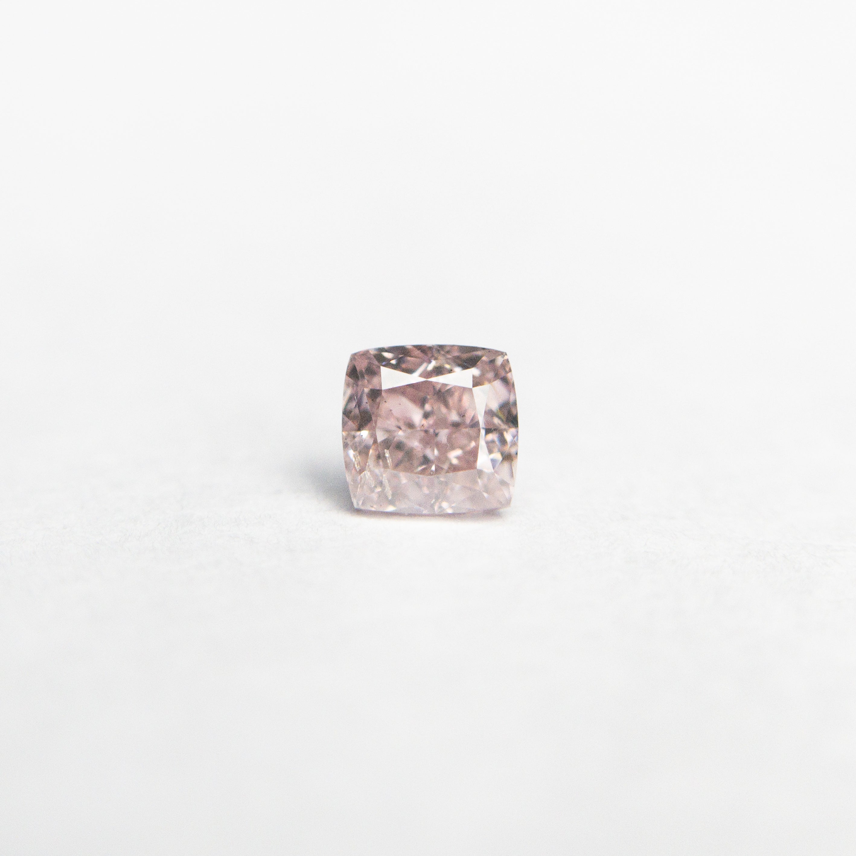 The 0.20ct 3.16x3.06x2.13mm GIA SI2 Fancy Pink Cushion Brilliant 🇦🇺 24099-01 by East London jeweller Rachel Boston | Discover our collections of unique and timeless engagement rings, wedding rings, and modern fine jewellery.