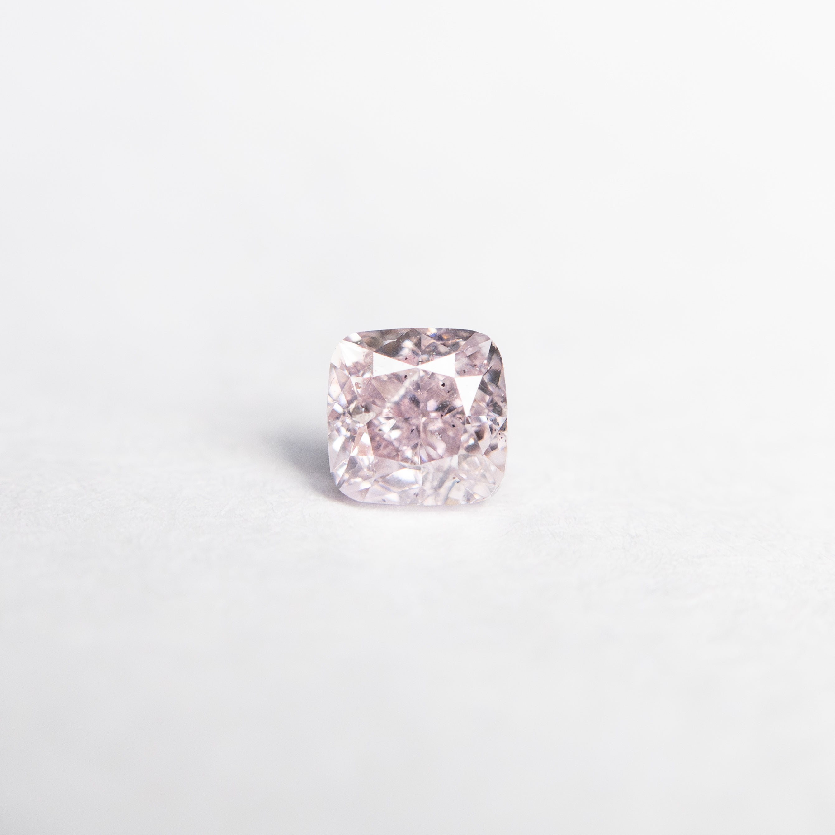 The 0.21ct 3.09x3.04x2.28mm GIA SI2 Fancy Purplish Pink Cushion Brilliant 🇦🇺 24097-01 by East London jeweller Rachel Boston | Discover our collections of unique and timeless engagement rings, wedding rings, and modern fine jewellery.