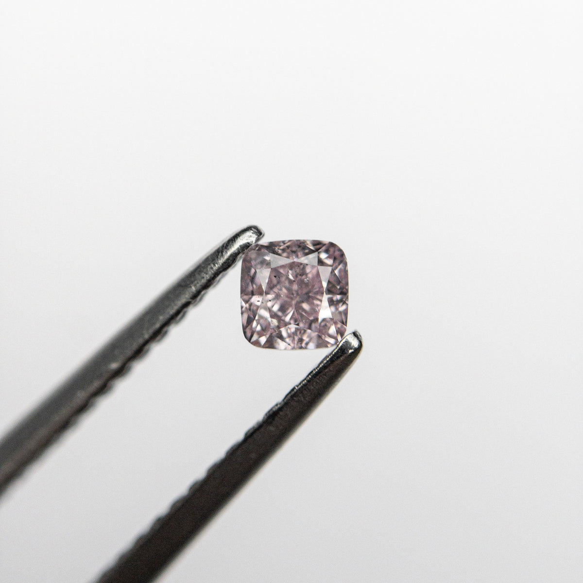 The 0.21ct 3.09x3.04x2.28mm GIA SI2 Fancy Purplish Pink Cushion Brilliant 🇦🇺 24097-01 by East London jeweller Rachel Boston | Discover our collections of unique and timeless engagement rings, wedding rings, and modern fine jewellery.