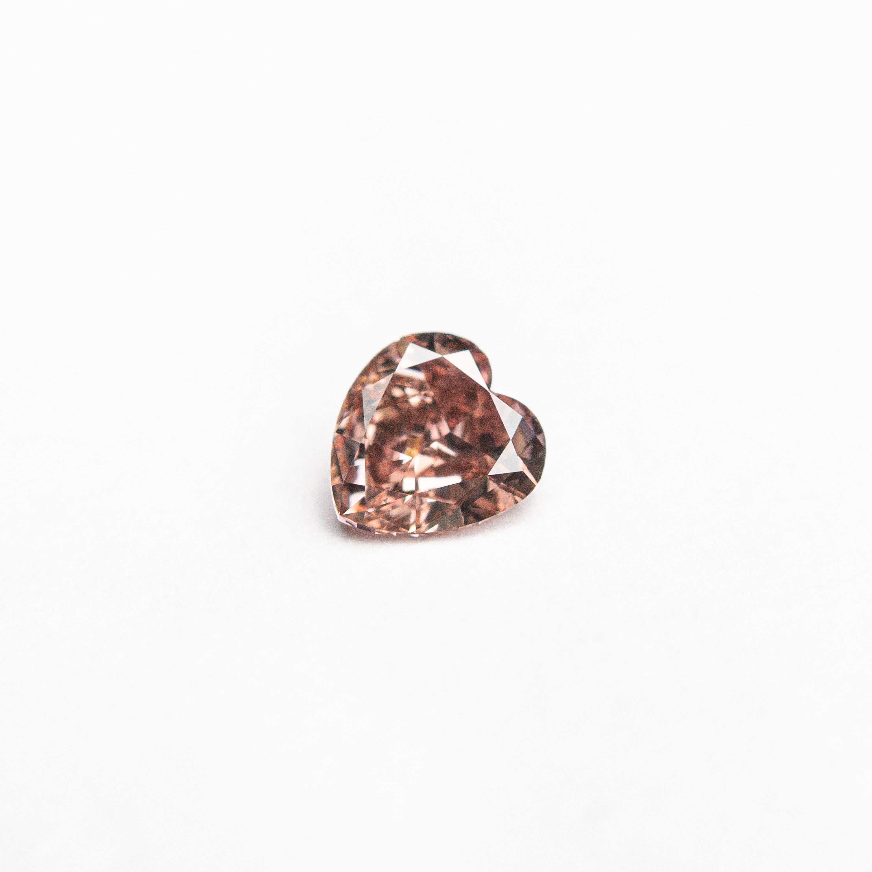 The 0.23ct 4.15x3.96x2.04mm GIA VS1 Fancy Deep Orangy Pink Heart Brilliant 🇦🇺 24121-01 by East London jeweller Rachel Boston | Discover our collections of unique and timeless engagement rings, wedding rings, and modern fine jewellery.