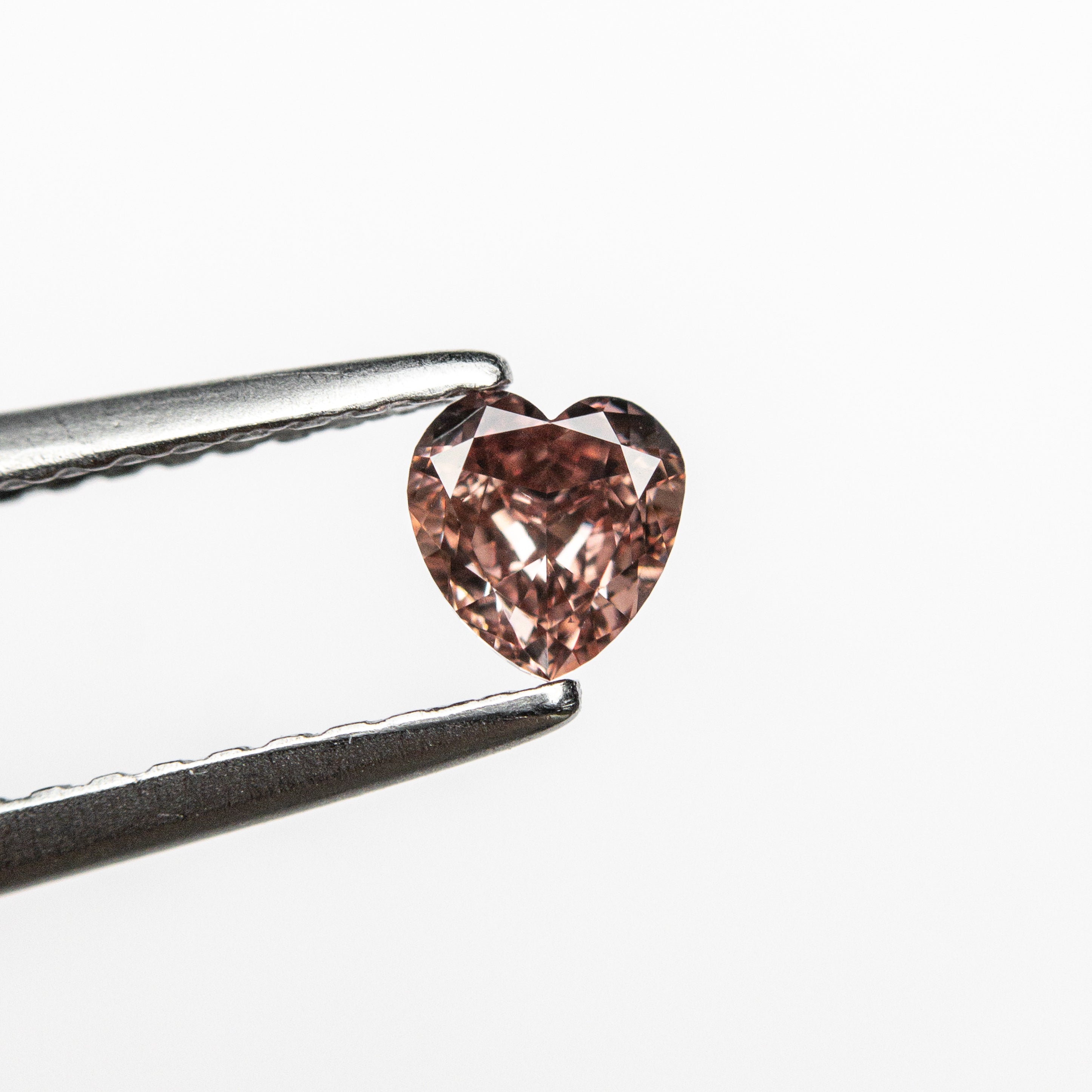The 0.23ct 4.15x3.96x2.04mm GIA VS1 Fancy Deep Orangy Pink Heart Brilliant 🇦🇺 24121-01 by East London jeweller Rachel Boston | Discover our collections of unique and timeless engagement rings, wedding rings, and modern fine jewellery.