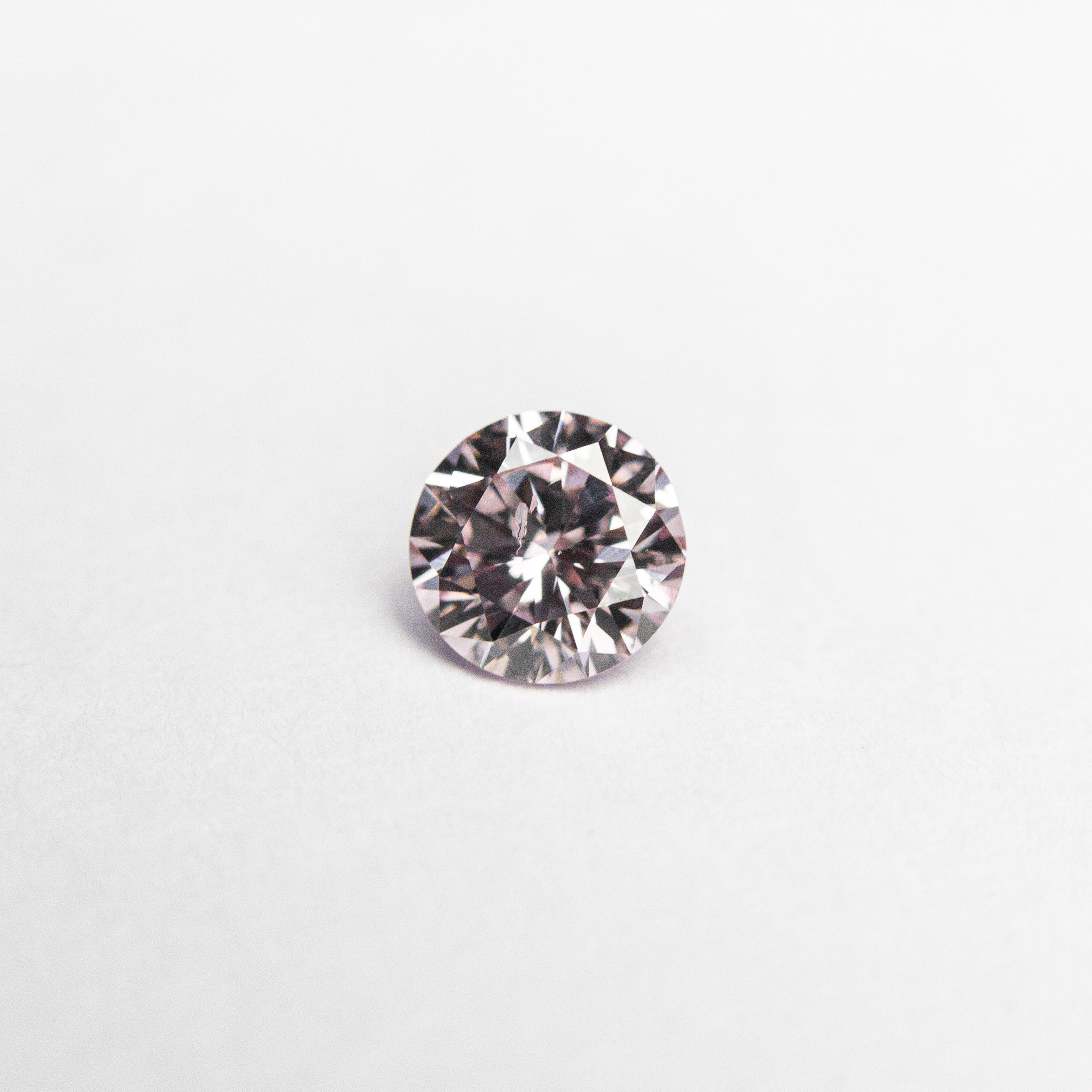 The 0.24ct 4.09x4.06x2.43 GIA Fancy Purplish Pink Round Brilliant 24166-01 by East London jeweller Rachel Boston | Discover our collections of unique and timeless engagement rings, wedding rings, and modern fine jewellery.