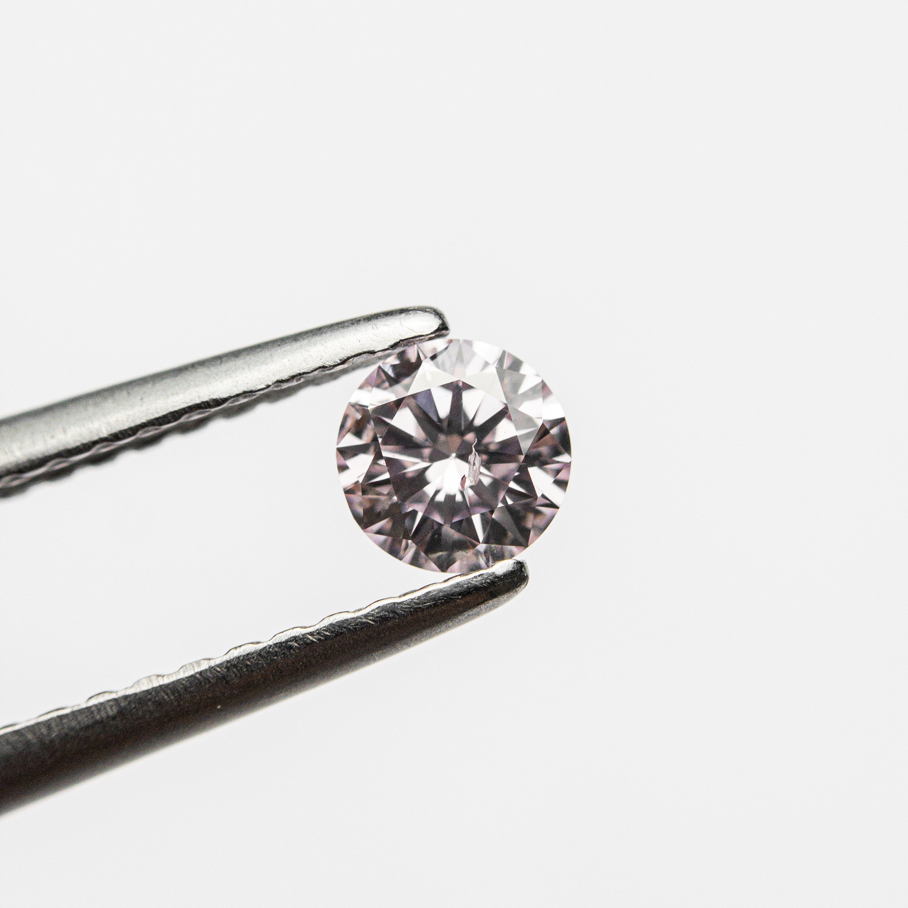 The 0.24ct 4.09x4.06x2.43 GIA Fancy Purplish Pink Round Brilliant 24166-01 by East London jeweller Rachel Boston | Discover our collections of unique and timeless engagement rings, wedding rings, and modern fine jewellery.