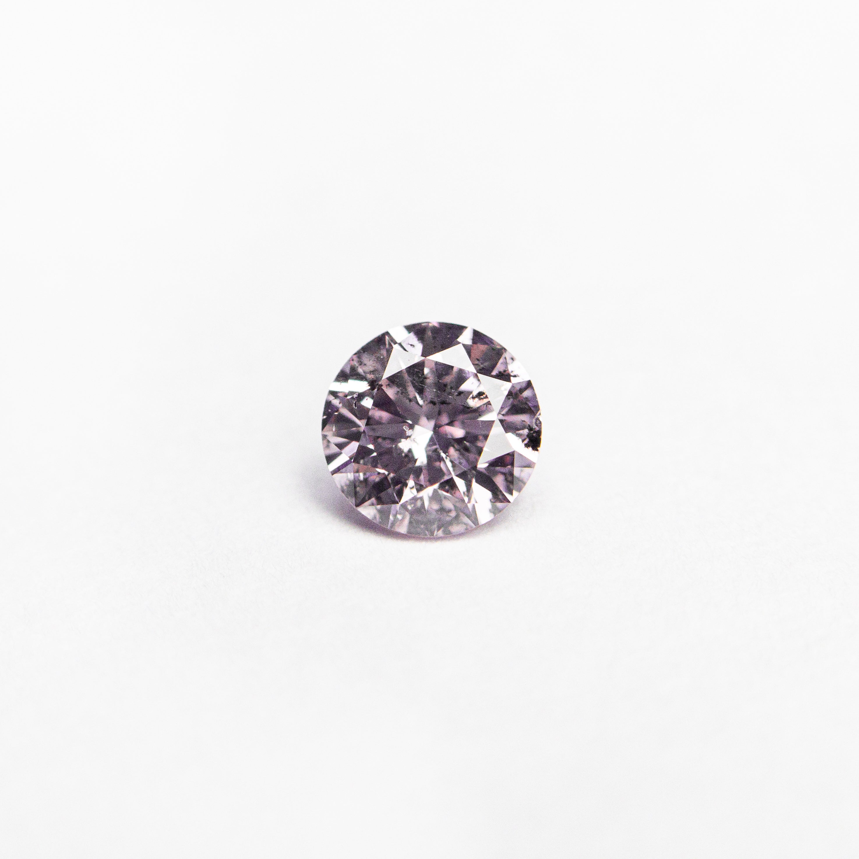 The 0.25ct 4.11x4.09x2.47mm GIA I1 Fancy Purple-Pink Round Brilliant 24143-01 by East London jeweller Rachel Boston | Discover our collections of unique and timeless engagement rings, wedding rings, and modern fine jewellery.