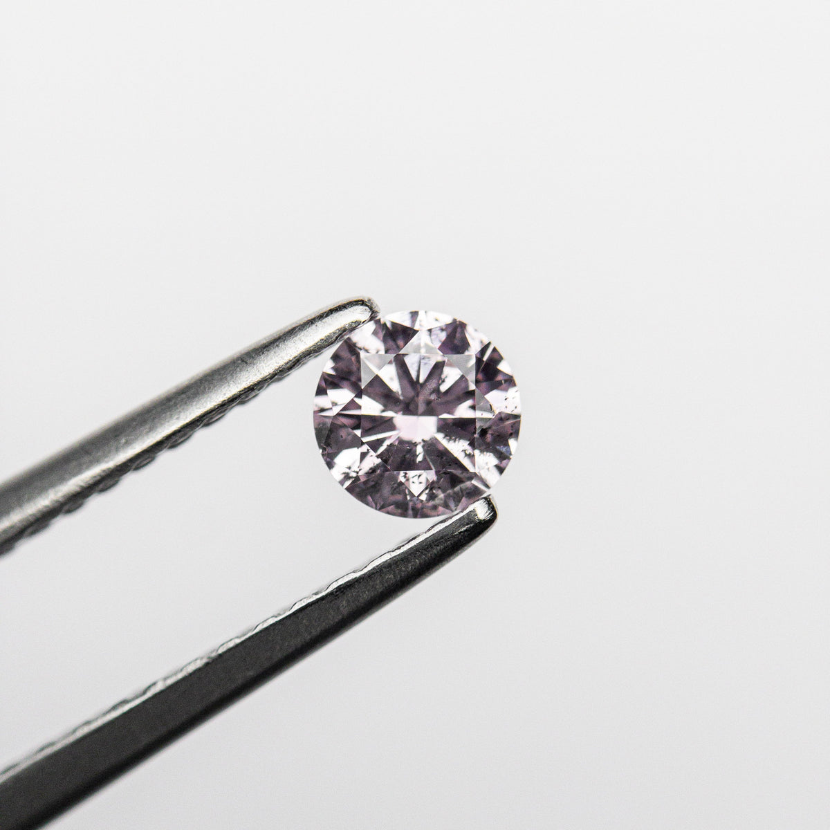 The 0.25ct 4.11x4.09x2.47mm GIA I1 Fancy Purple-Pink Round Brilliant 24143-01 by East London jeweller Rachel Boston | Discover our collections of unique and timeless engagement rings, wedding rings, and modern fine jewellery.