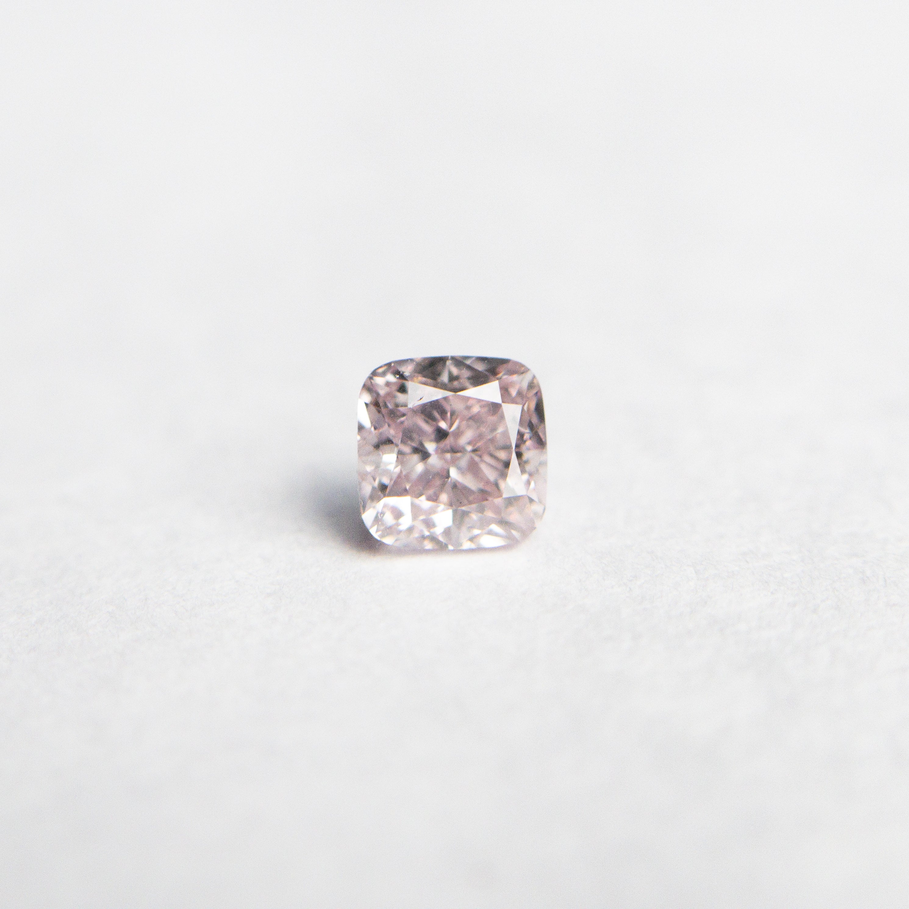The 0.26ct 3.42x3.37x2.43mm GIA SI1 Fancy Purplish Pink Cushion Brilliant 🇦🇺 24102-01 by East London jeweller Rachel Boston | Discover our collections of unique and timeless engagement rings, wedding rings, and modern fine jewellery.