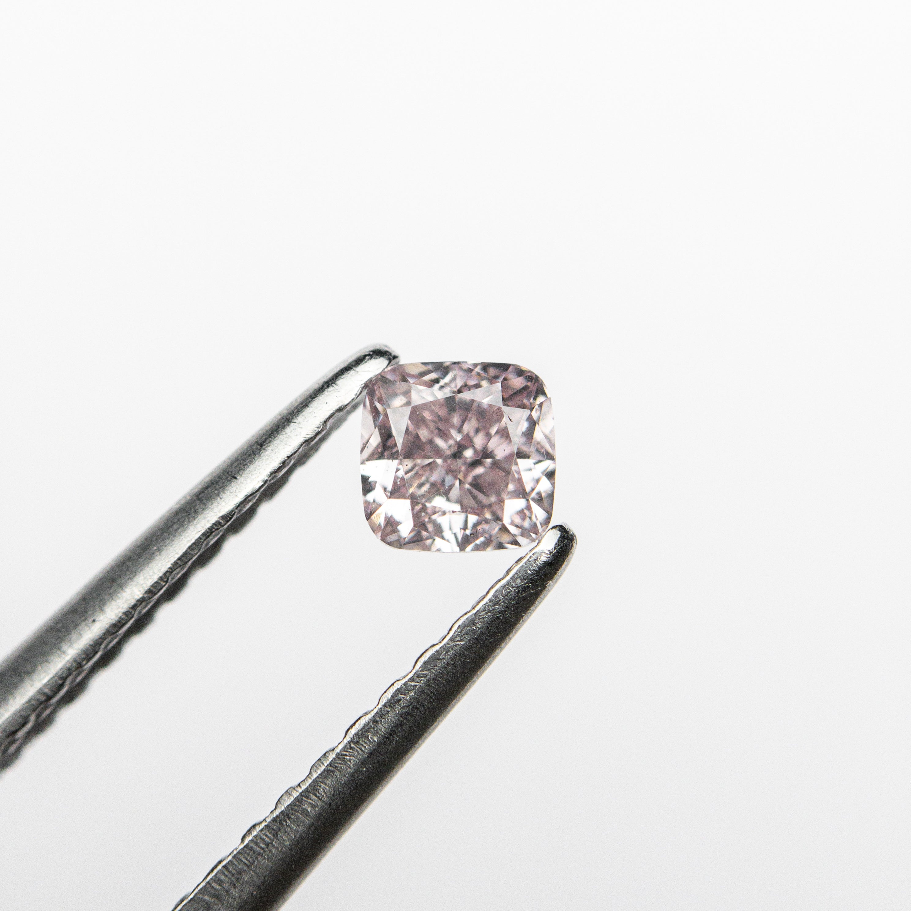The 0.26ct 3.42x3.37x2.43mm GIA SI1 Fancy Purplish Pink Cushion Brilliant 🇦🇺 24102-01 by East London jeweller Rachel Boston | Discover our collections of unique and timeless engagement rings, wedding rings, and modern fine jewellery.