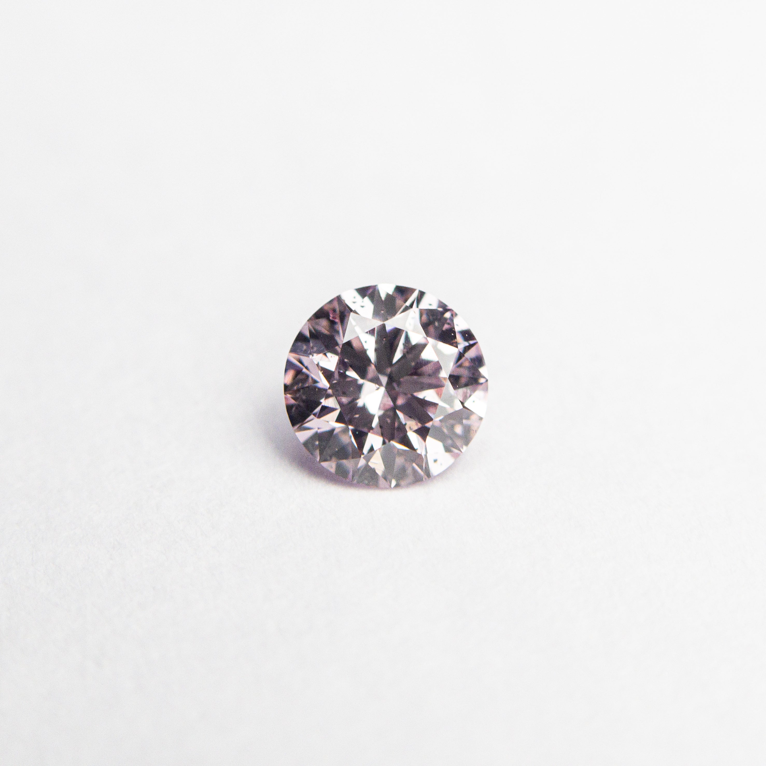 The 0.28ct 4.28x4.25x2.56mm GIA I1 Fancy Purplish Pink Round Brilliant 24167-01 by East London jeweller Rachel Boston | Discover our collections of unique and timeless engagement rings, wedding rings, and modern fine jewellery.
