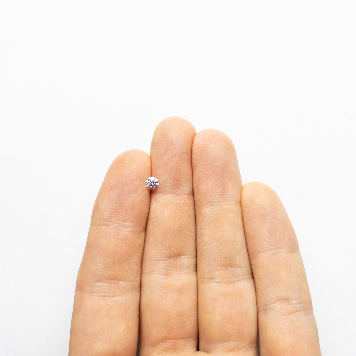 The 0.28ct 4.28x4.25x2.56mm GIA I1 Fancy Purplish Pink Round Brilliant 24167-01 by East London jeweller Rachel Boston | Discover our collections of unique and timeless engagement rings, wedding rings, and modern fine jewellery.