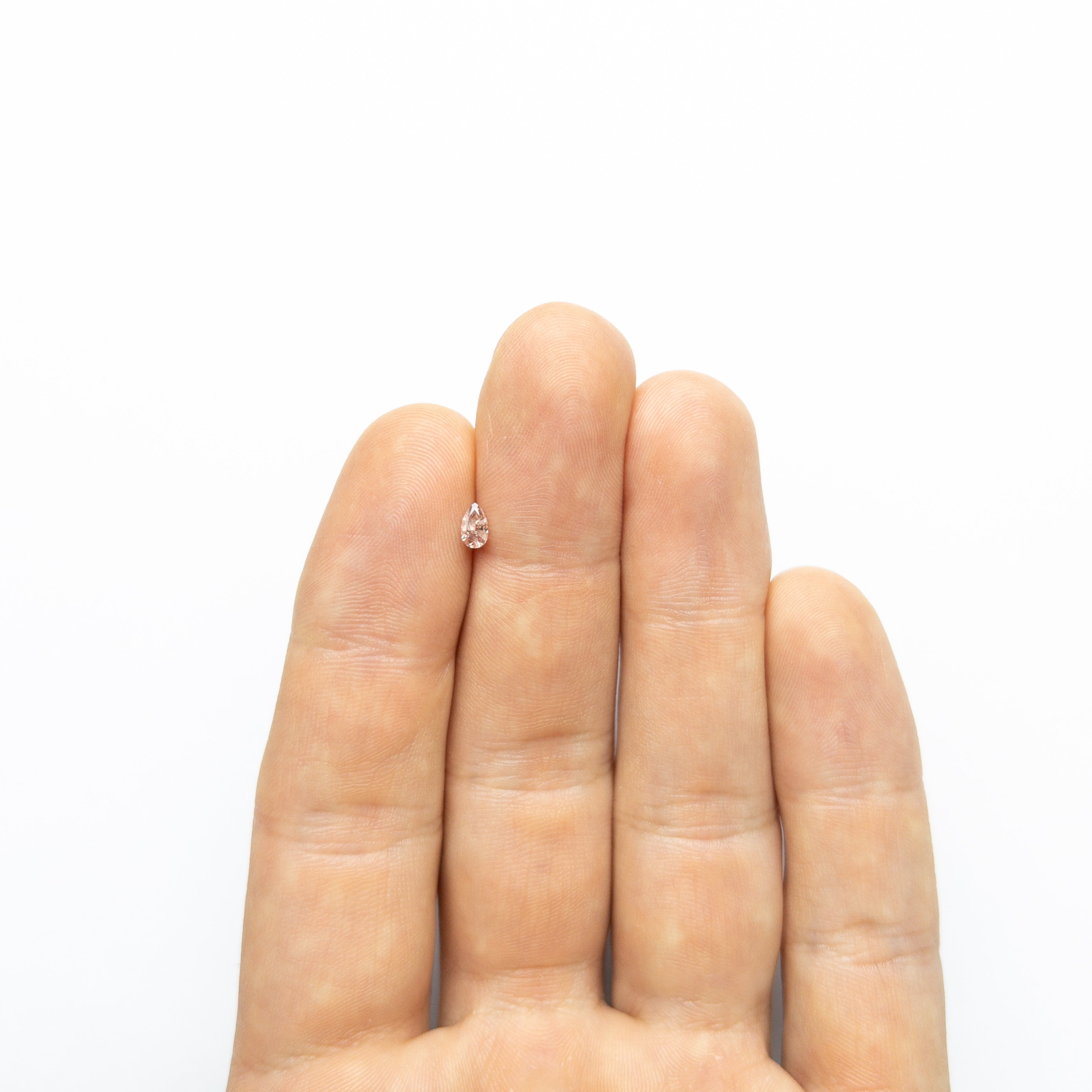 The 0.26ct 4.93x2.92x2.15mm Fancy Pink Pear Brilliant 24106-01 by East London jeweller Rachel Boston | Discover our collections of unique and timeless engagement rings, wedding rings, and modern fine jewellery.