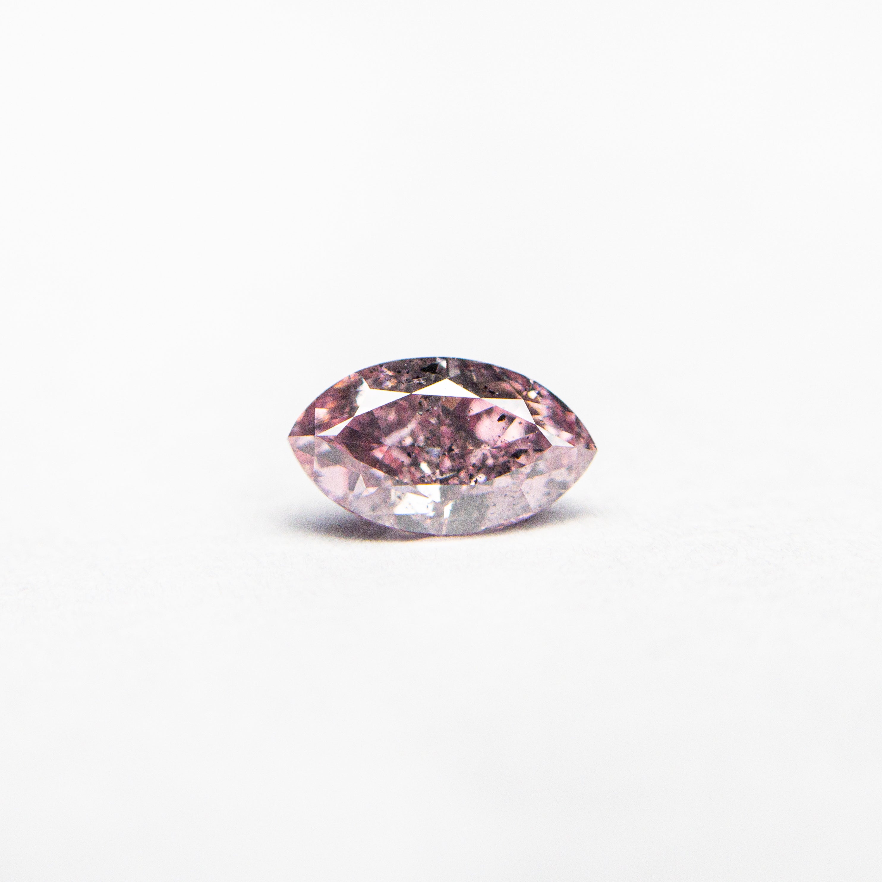 The 0.29ct 5.70x3.27x2.29mm GIA I1 Fancy Intense Purplish Pink Marquise Brilliant 24148-01 by East London jeweller Rachel Boston | Discover our collections of unique and timeless engagement rings, wedding rings, and modern fine jewellery.