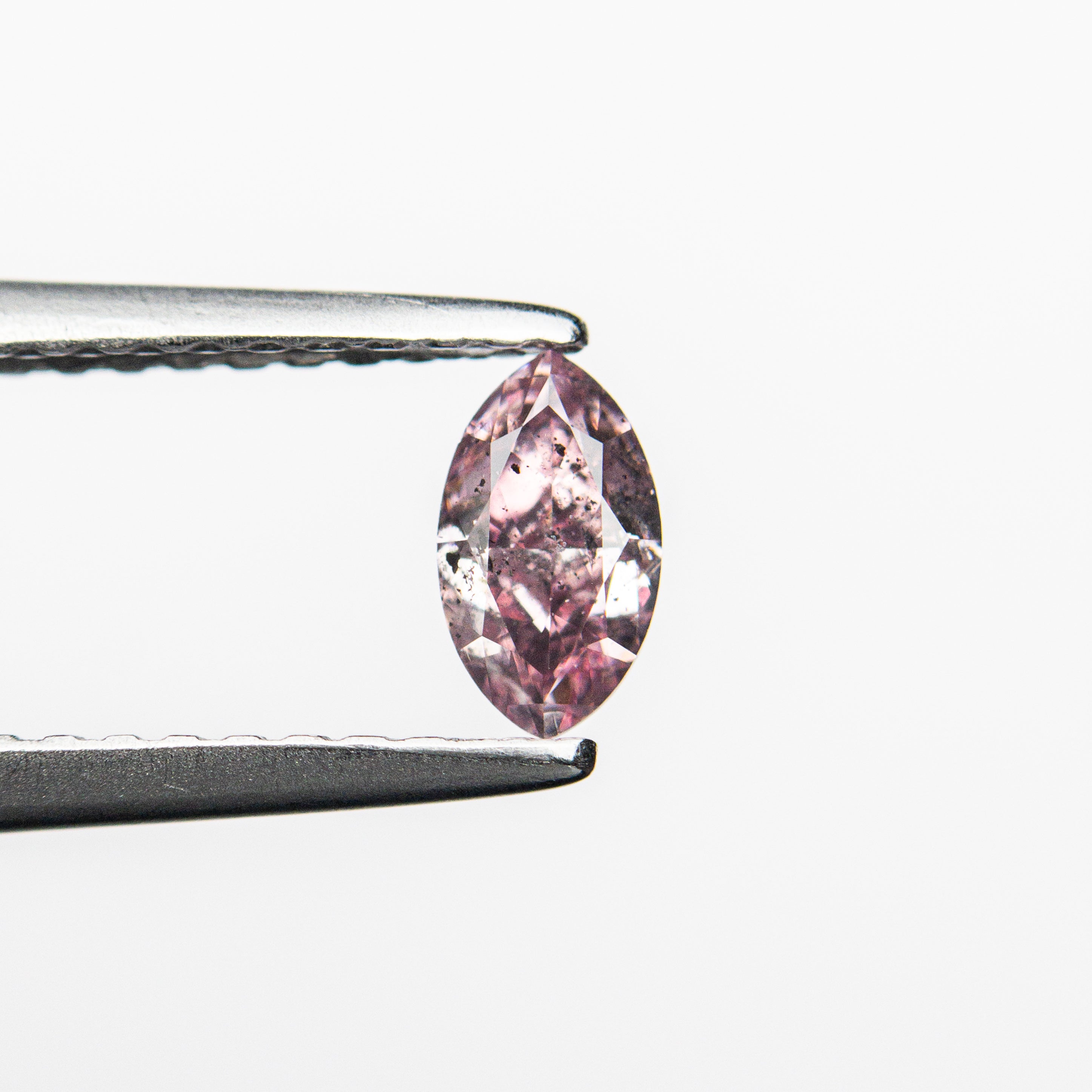 The 0.29ct 5.70x3.27x2.29mm GIA I1 Fancy Intense Purplish Pink Marquise Brilliant 24148-01 by East London jeweller Rachel Boston | Discover our collections of unique and timeless engagement rings, wedding rings, and modern fine jewellery.