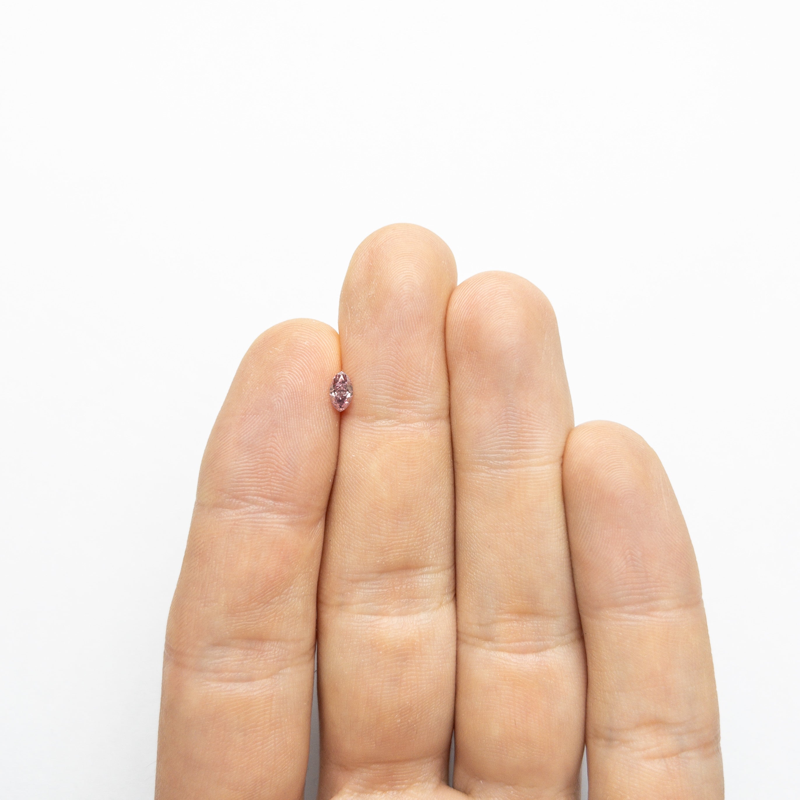 The 0.29ct 5.70x3.27x2.29mm GIA I1 Fancy Intense Purplish Pink Marquise Brilliant 24148-01 by East London jeweller Rachel Boston | Discover our collections of unique and timeless engagement rings, wedding rings, and modern fine jewellery.