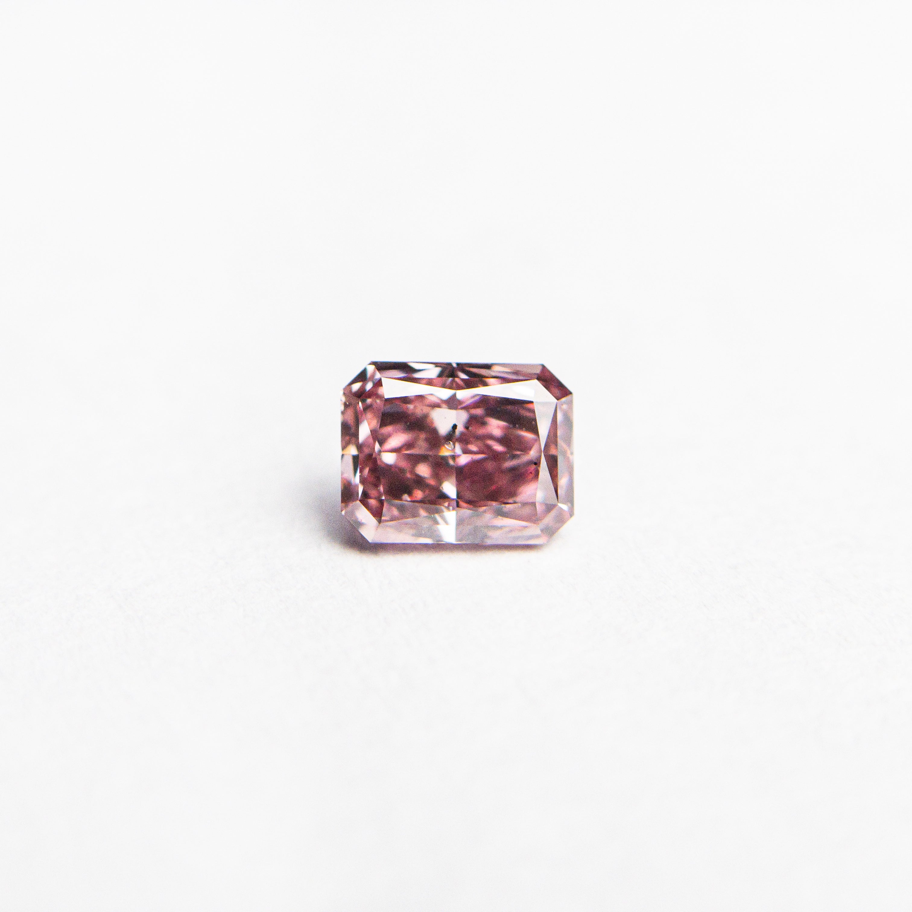 The 0.30ct 4.22x3.28x2.29mm GIA SI2 Fancy Pink Cut Corner Rectangle Brilliant 24156-01 by East London jeweller Rachel Boston | Discover our collections of unique and timeless engagement rings, wedding rings, and modern fine jewellery.