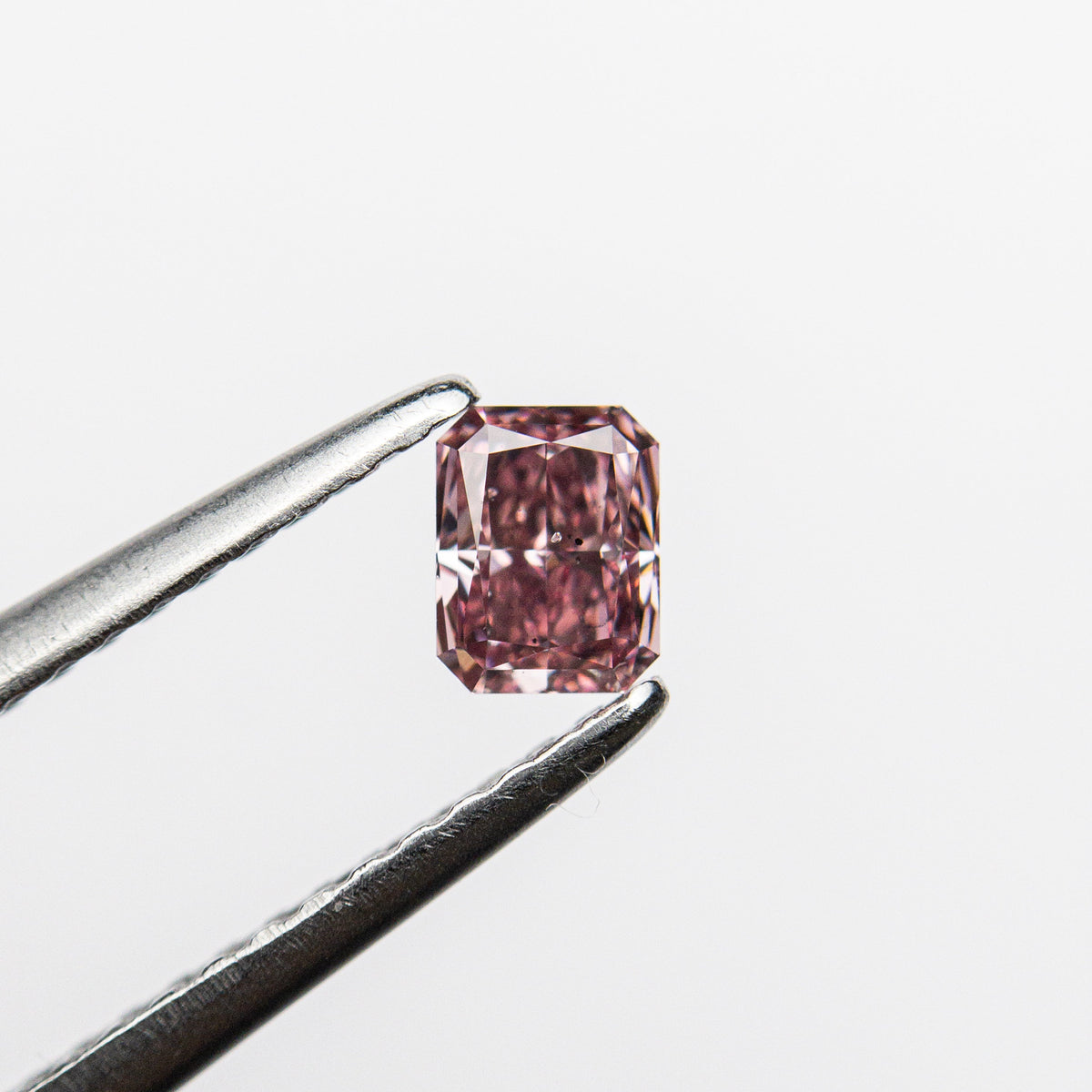 The 0.30ct 4.22x3.28x2.29mm GIA SI2 Fancy Pink Cut Corner Rectangle Brilliant 24156-01 by East London jeweller Rachel Boston | Discover our collections of unique and timeless engagement rings, wedding rings, and modern fine jewellery.