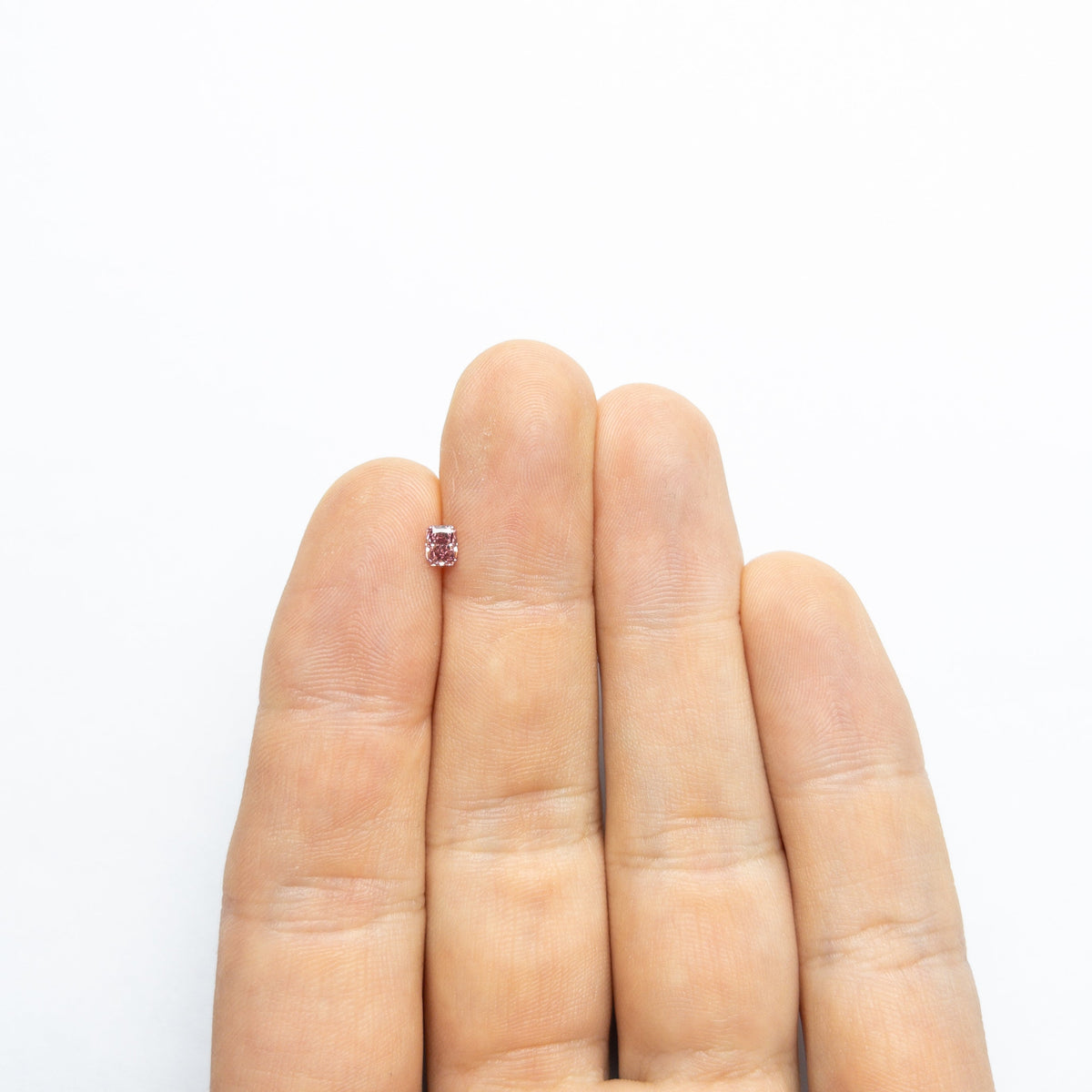 The 0.30ct 4.22x3.28x2.29mm GIA SI2 Fancy Pink Cut Corner Rectangle Brilliant 24156-01 by East London jeweller Rachel Boston | Discover our collections of unique and timeless engagement rings, wedding rings, and modern fine jewellery.
