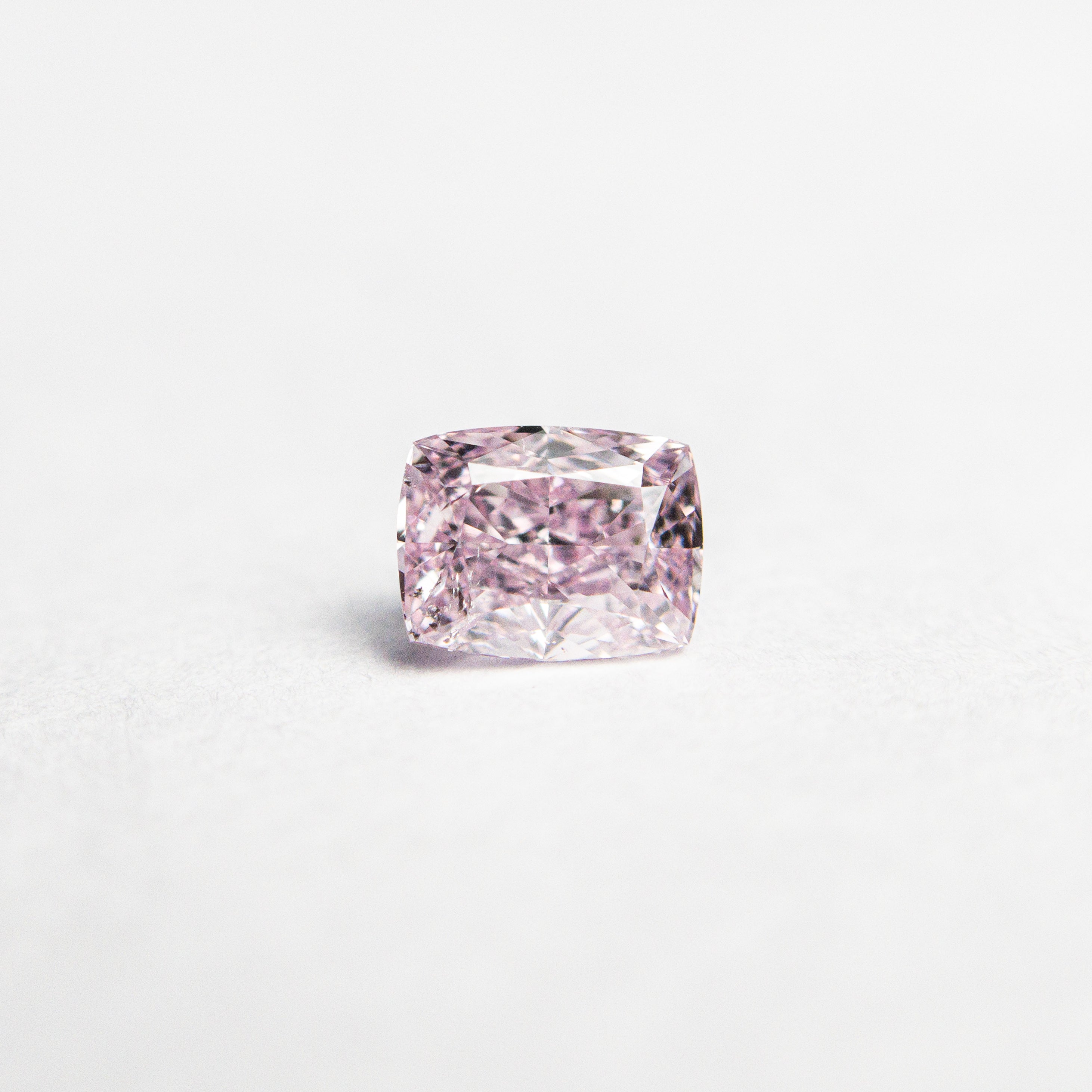 The 0.30ct 4.43x3.39x2.27mm GIA SI2 Fancy Intense Purple-Pink Cushion Brilliant 🇨🇦 24164-01 by East London jeweller Rachel Boston | Discover our collections of unique and timeless engagement rings, wedding rings, and modern fine jewellery.