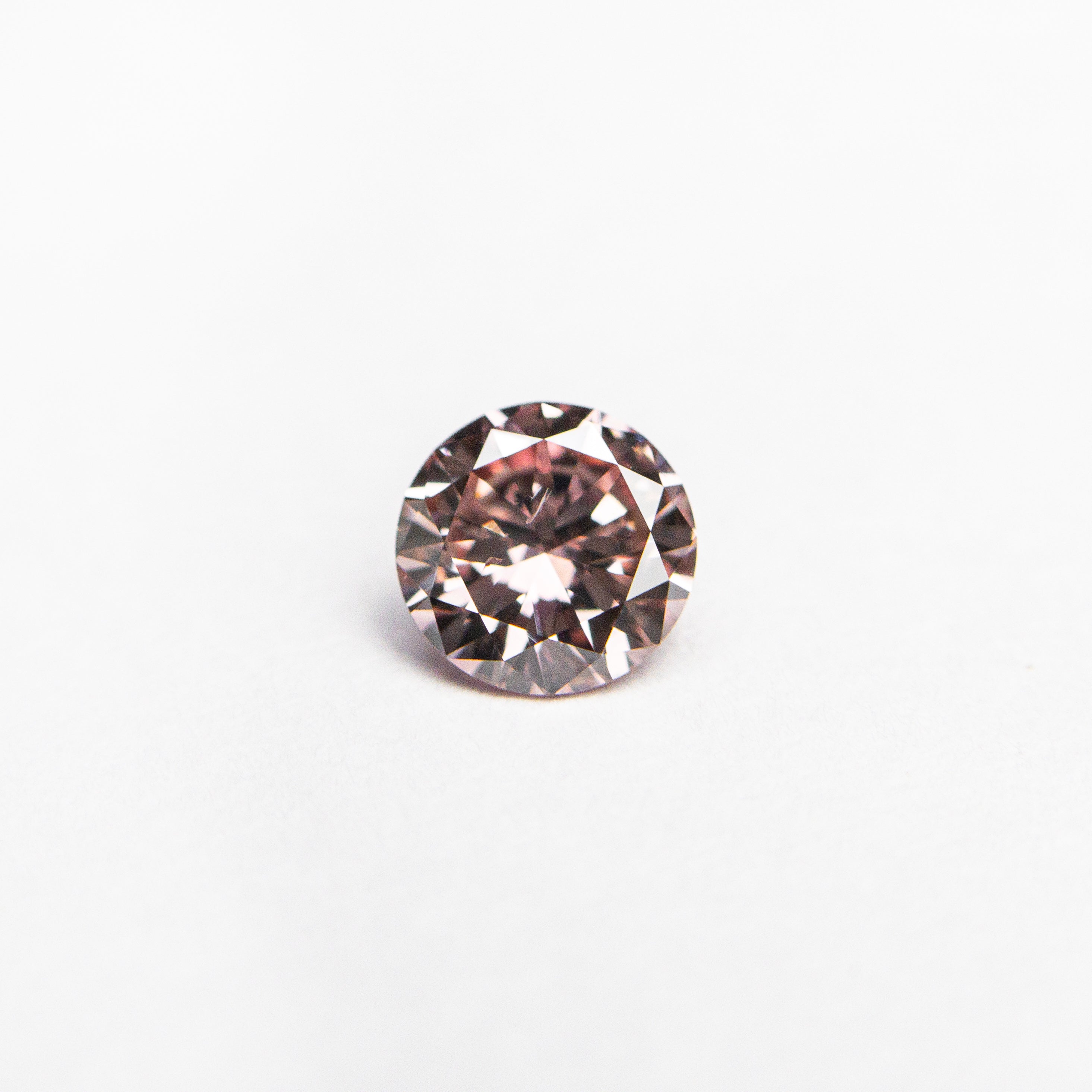 The 0.30ct 4.43x4.41x2.45mm GIA SI2 Fancy Intense Pink Round Brilliant 24144-01 by East London jeweller Rachel Boston | Discover our collections of unique and timeless engagement rings, wedding rings, and modern fine jewellery.