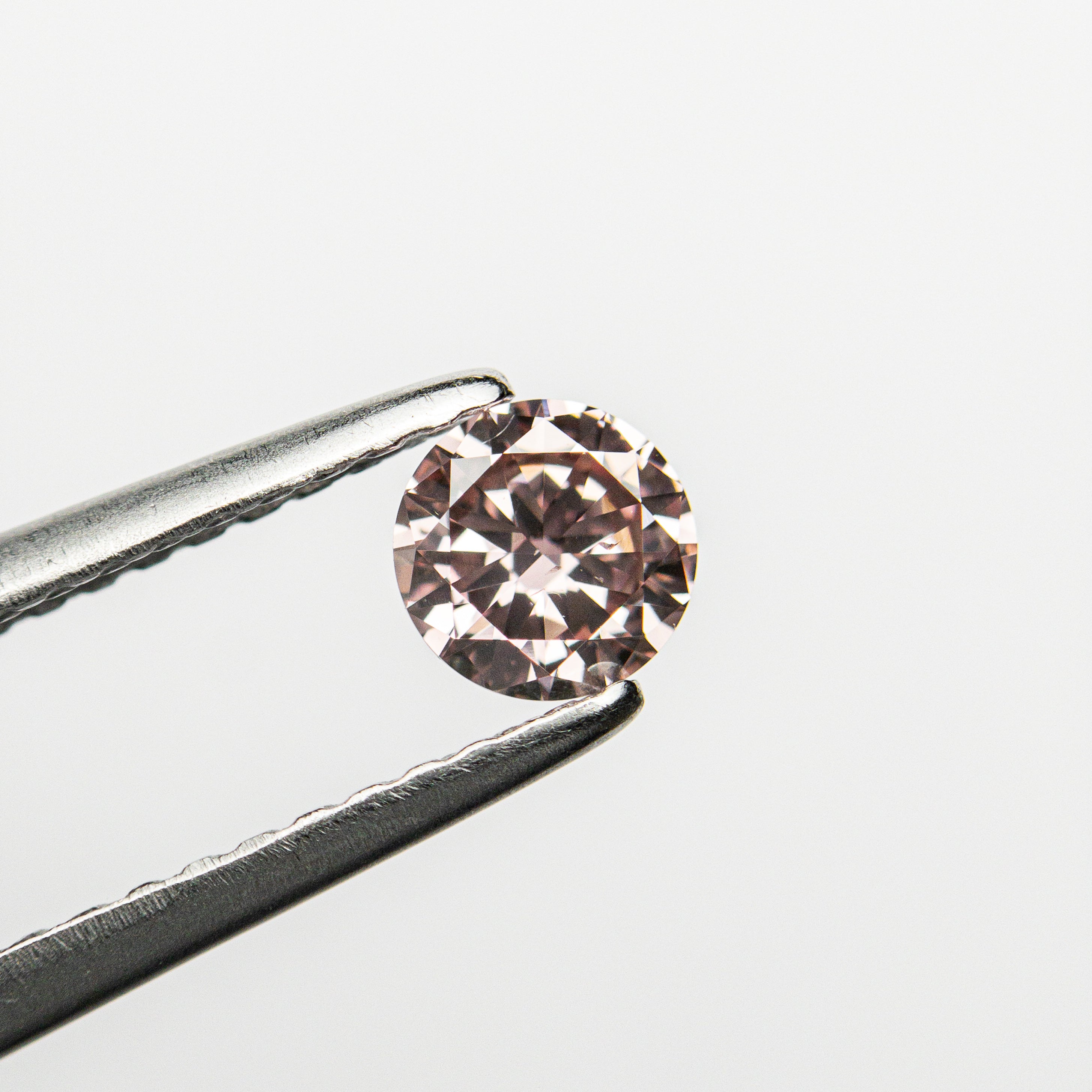 The 0.30ct 4.43x4.41x2.45mm GIA SI2 Fancy Intense Pink Round Brilliant 24144-01 by East London jeweller Rachel Boston | Discover our collections of unique and timeless engagement rings, wedding rings, and modern fine jewellery.
