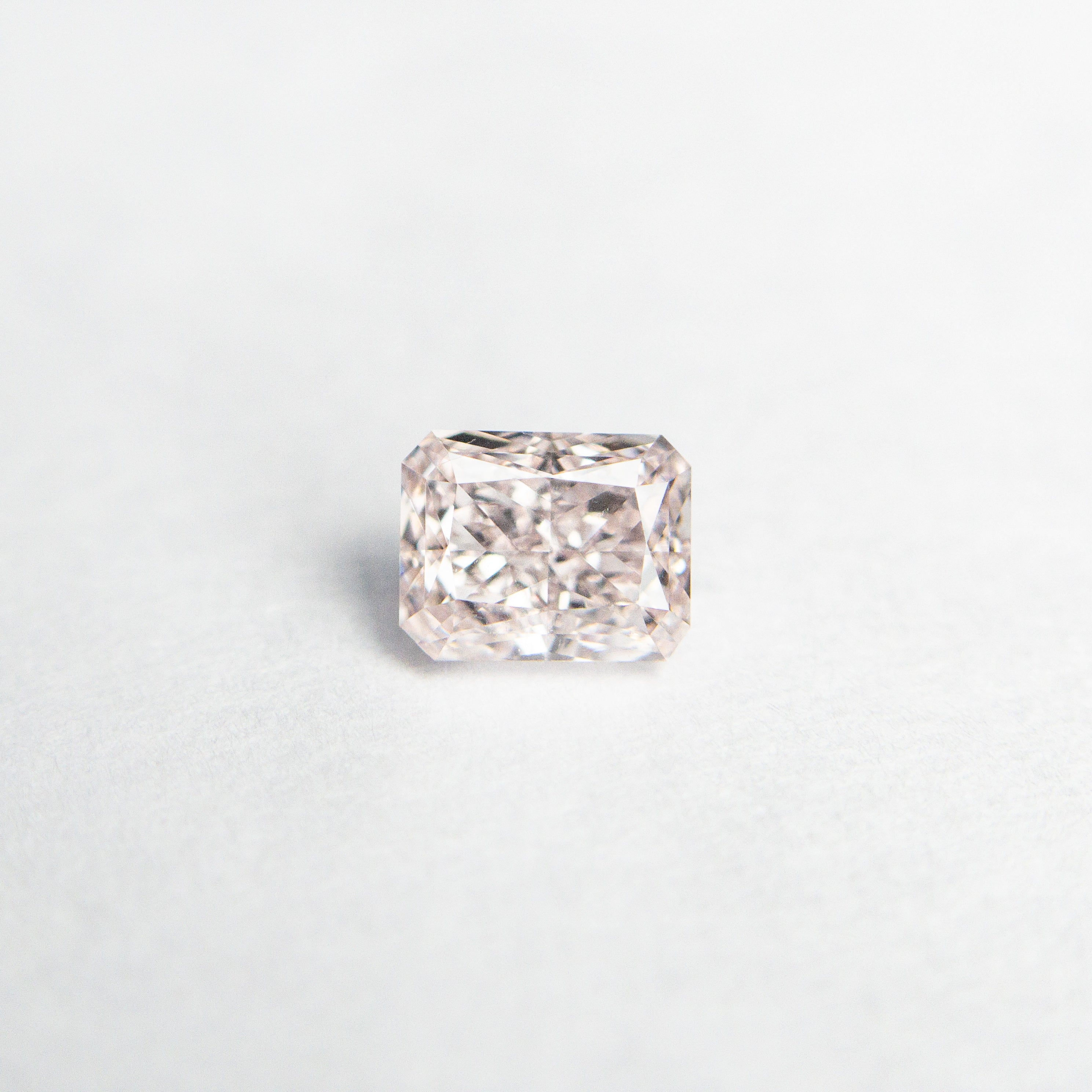 The 0.31ct 4.24x3.36x2.27mm GIA SI1 Fancy Pink Cut Corner Rectangle Brilliant 24095-01 by East London jeweller Rachel Boston | Discover our collections of unique and timeless engagement rings, wedding rings, and modern fine jewellery.