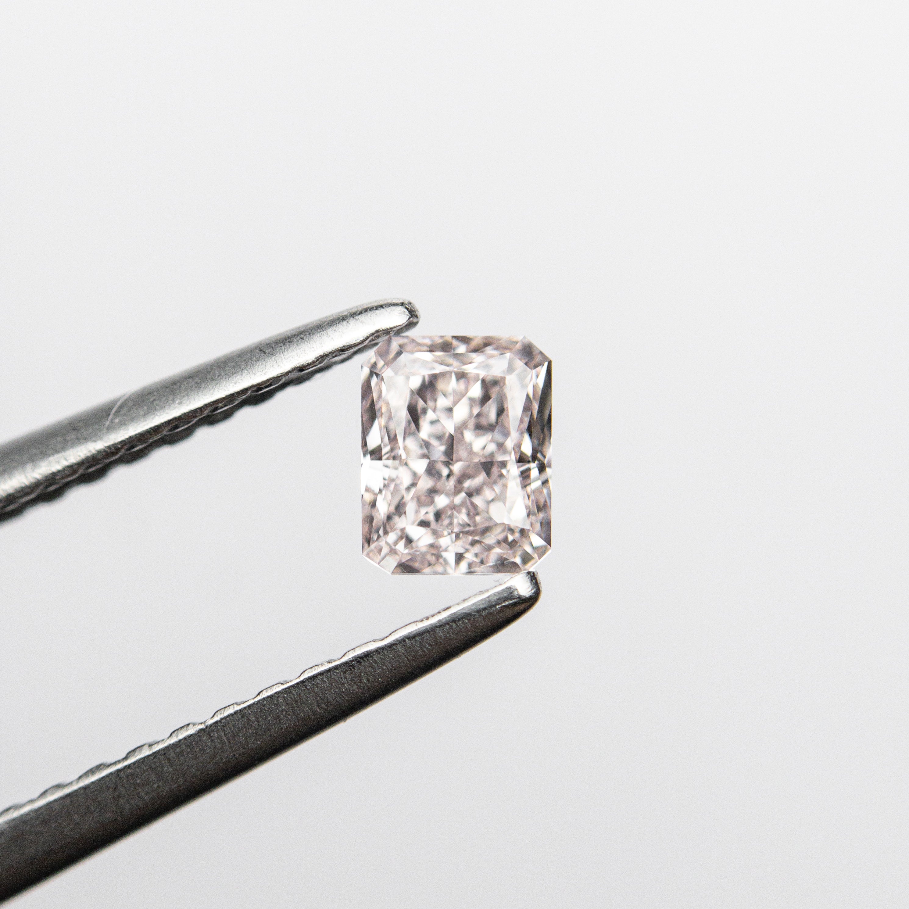 The 0.31ct 4.24x3.36x2.27mm GIA SI1 Fancy Pink Cut Corner Rectangle Brilliant 24095-01 by East London jeweller Rachel Boston | Discover our collections of unique and timeless engagement rings, wedding rings, and modern fine jewellery.