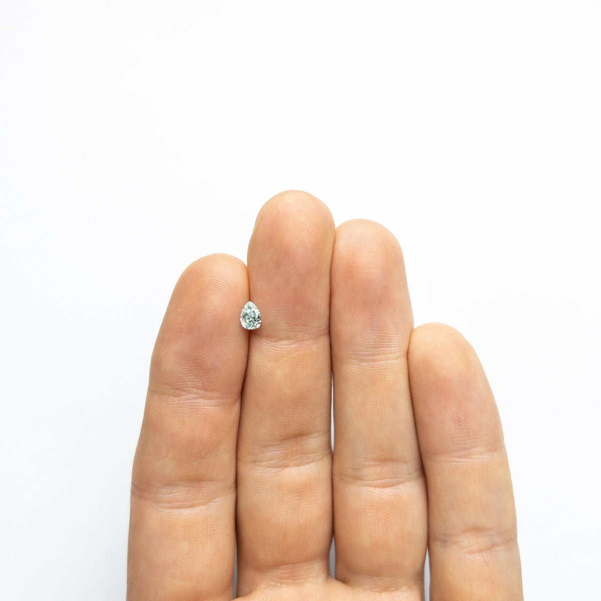 The 0.32ct 5.48x3.95x2.17mm GIA VVS2 Fancy Vivid Bluish Green Pear Brilliant 24131-01 by East London jeweller Rachel Boston | Discover our collections of unique and timeless engagement rings, wedding rings, and modern fine jewellery.