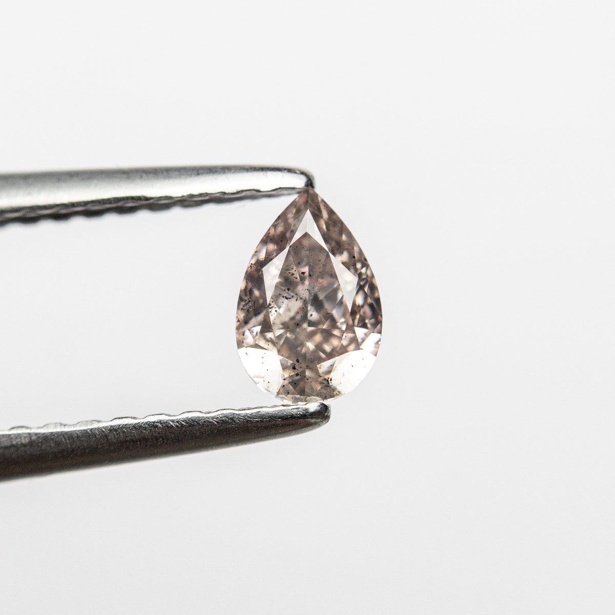 The 0.34ct 5.35x3.56x2.35mm I1 Fancy Pink-Brown Pear Brilliant 24119-01 by East London jeweller Rachel Boston | Discover our collections of unique and timeless engagement rings, wedding rings, and modern fine jewellery.
