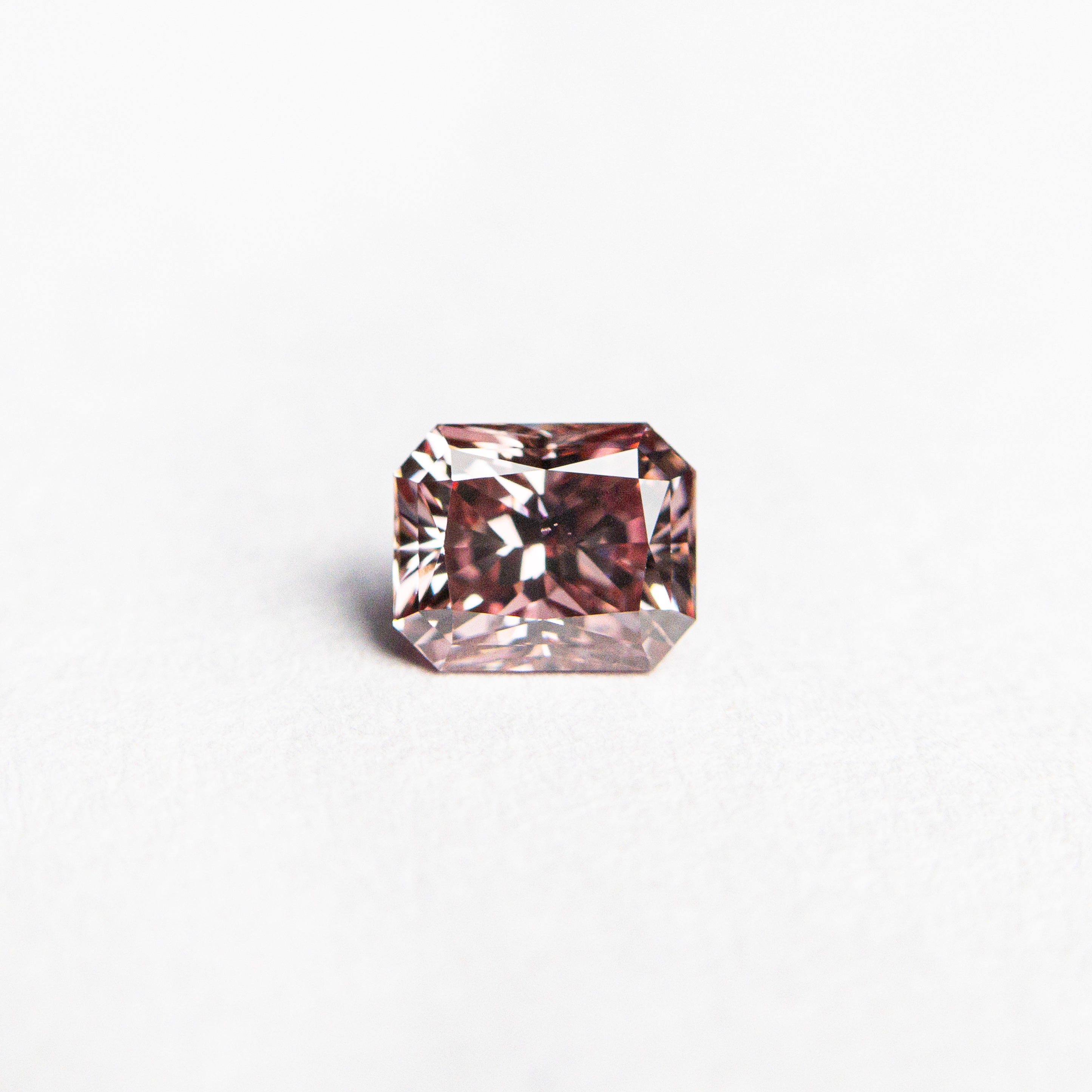 The 0.35ct 4.40x3.60x2.73mm GIA SI1 Fancy Deep Pink Cut Corner Rectangle Brilliant 24155-01 by East London jeweller Rachel Boston | Discover our collections of unique and timeless engagement rings, wedding rings, and modern fine jewellery.