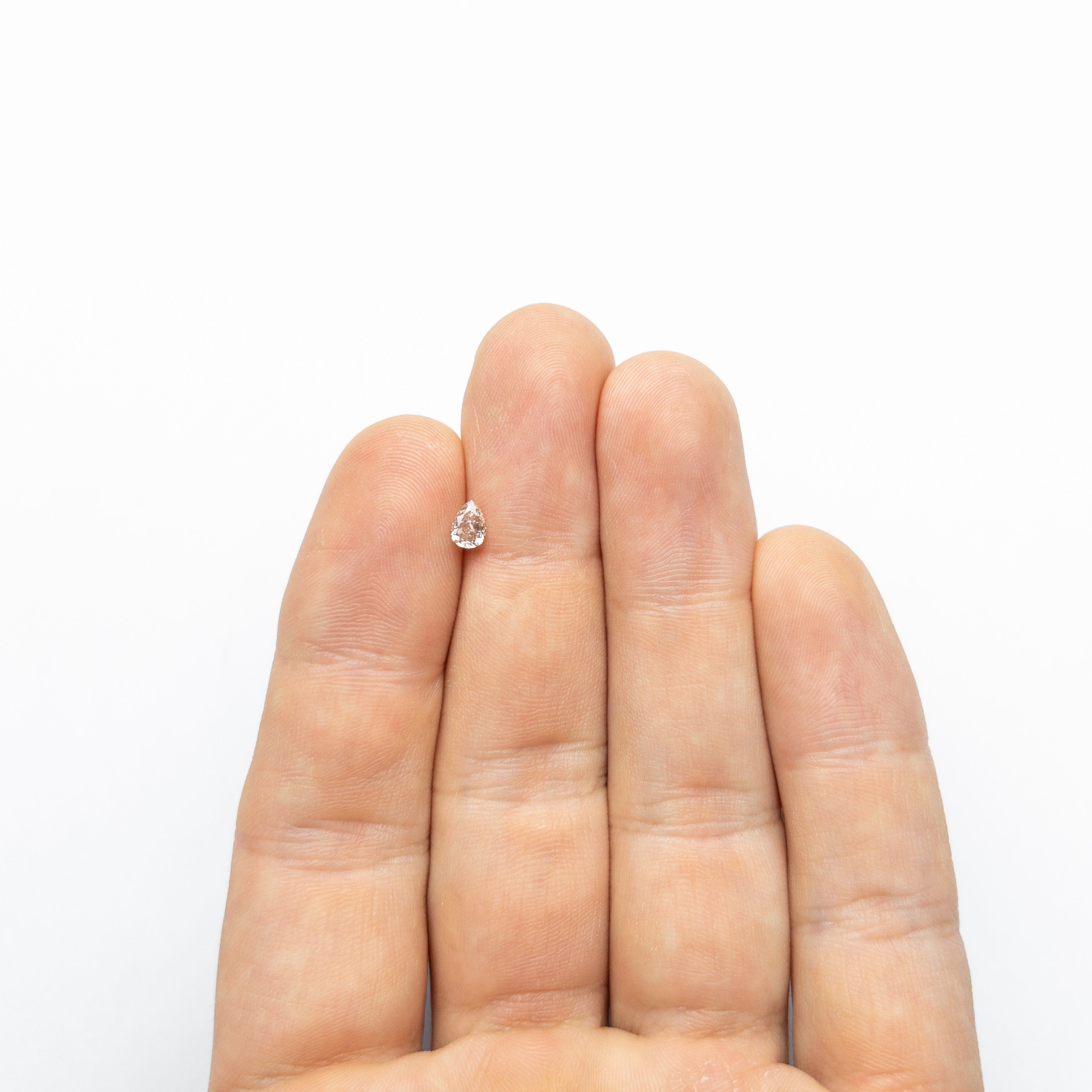 The 0.35ct 5.24x3.75x2.45mm GIA VS2 Fancy Brown-Pink Pear Brilliant 🇦🇺 24093-01 by East London jeweller Rachel Boston | Discover our collections of unique and timeless engagement rings, wedding rings, and modern fine jewellery.