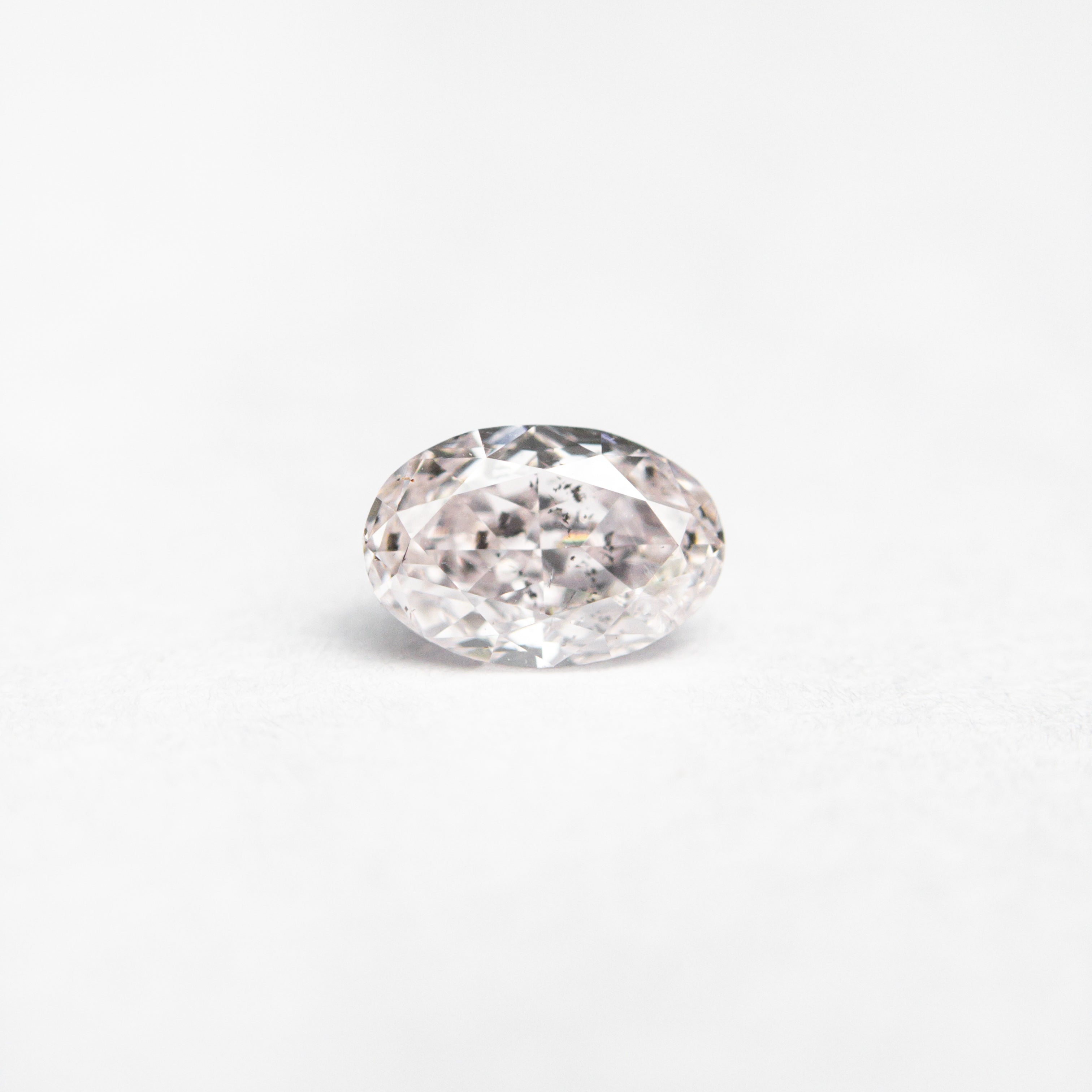 The 0.40ct 5.38x3.60x2.59mm GIA I1 Fancy Light Pink Oval Brilliant 24094-01 by East London jeweller Rachel Boston | Discover our collections of unique and timeless engagement rings, wedding rings, and modern fine jewellery.