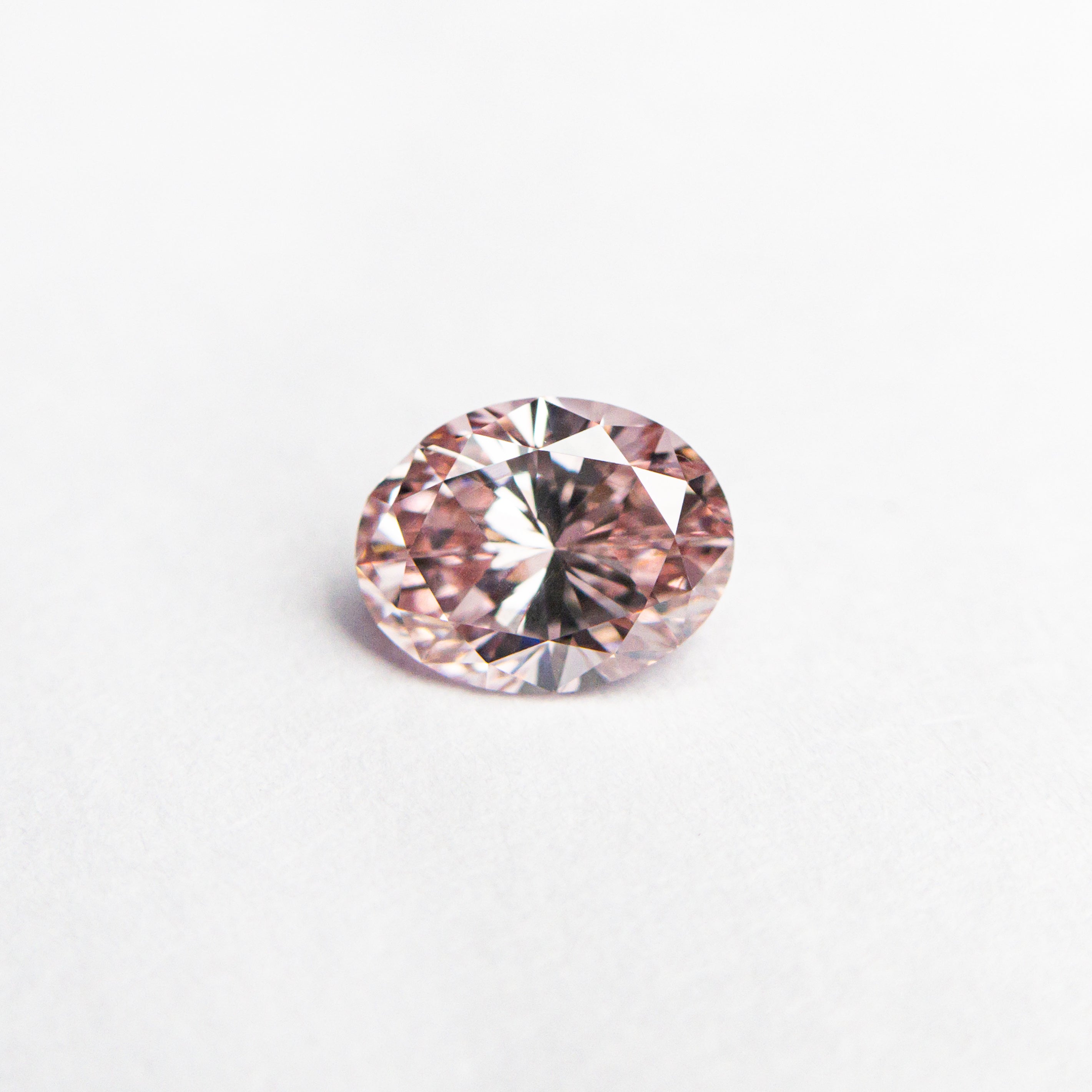 The 0.40ct 5.42x4.21x2.69mm GIA VS2 Fancy Intense Pink Oval Brilliant 24157-01 by East London jeweller Rachel Boston | Discover our collections of unique and timeless engagement rings, wedding rings, and modern fine jewellery.