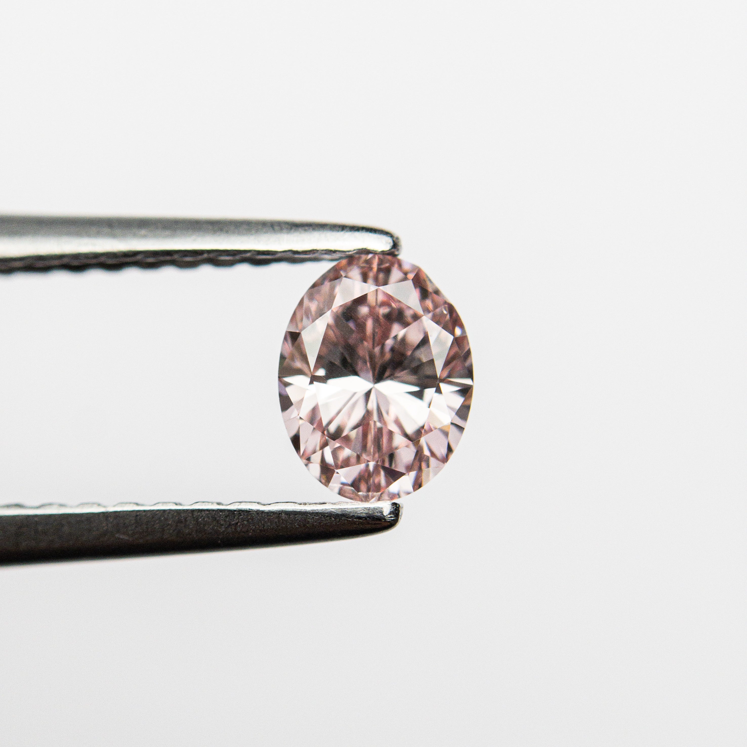 The 0.40ct 5.42x4.21x2.69mm GIA VS2 Fancy Intense Pink Oval Brilliant 24157-01 by East London jeweller Rachel Boston | Discover our collections of unique and timeless engagement rings, wedding rings, and modern fine jewellery.