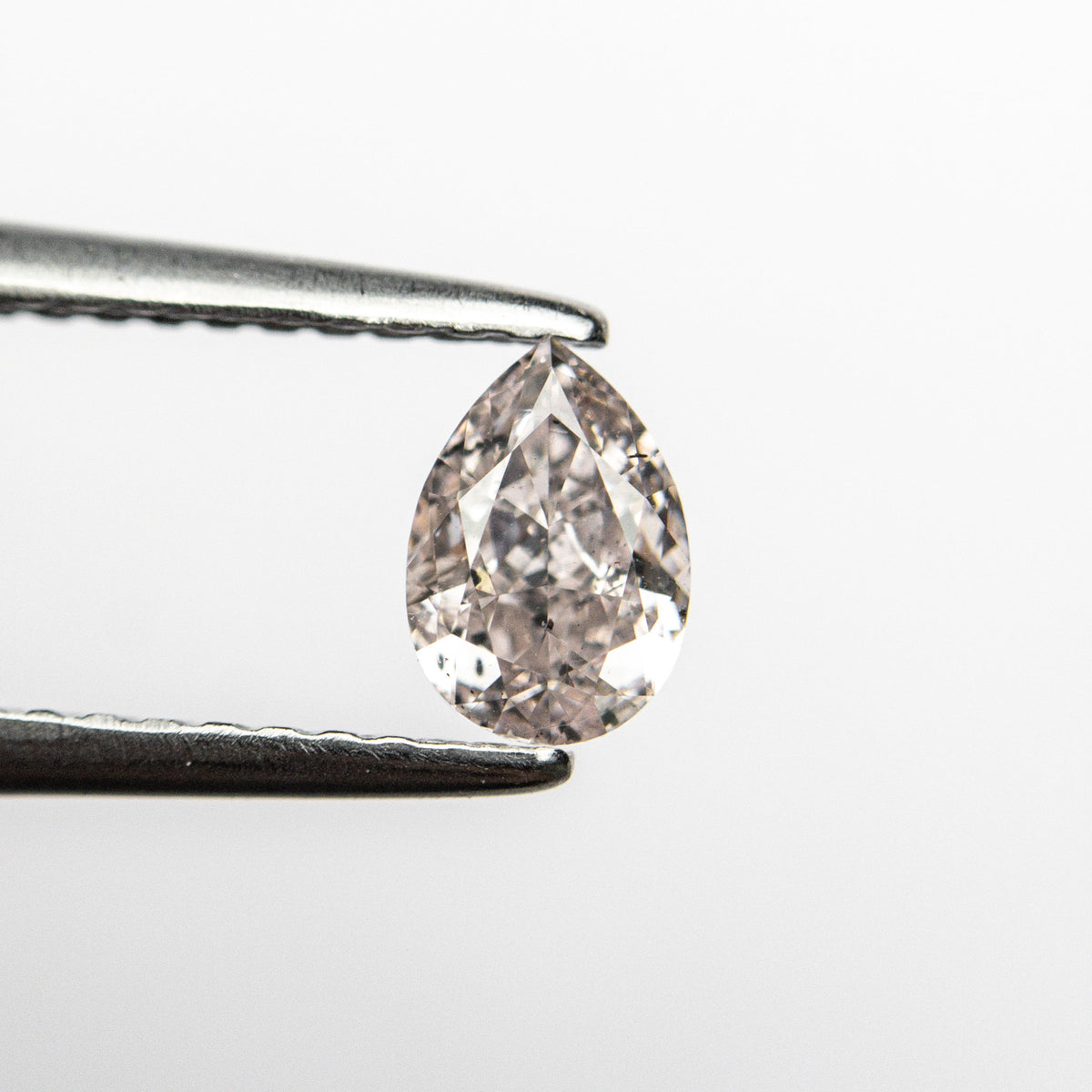 The 0.45ct 5.87x4.07x2.54mm Faint Pink Pear Brilliant 🇦🇺 24117-01 by East London jeweller Rachel Boston | Discover our collections of unique and timeless engagement rings, wedding rings, and modern fine jewellery.