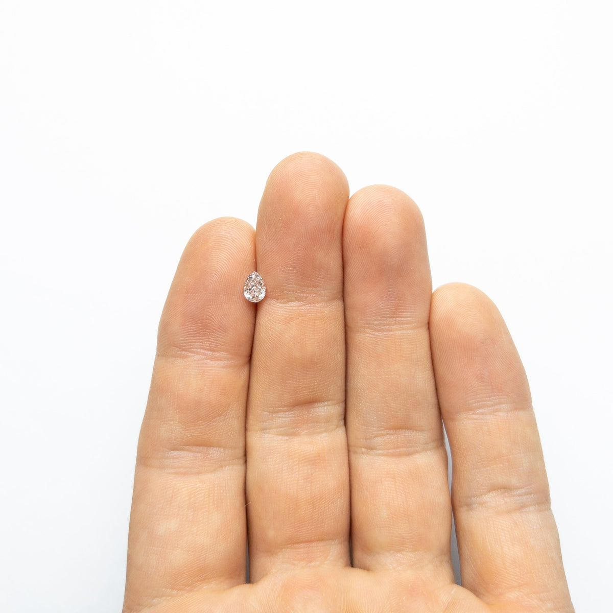 The 0.45ct 5.87x4.07x2.54mm Faint Pink Pear Brilliant 🇦🇺 24117-01 by East London jeweller Rachel Boston | Discover our collections of unique and timeless engagement rings, wedding rings, and modern fine jewellery.