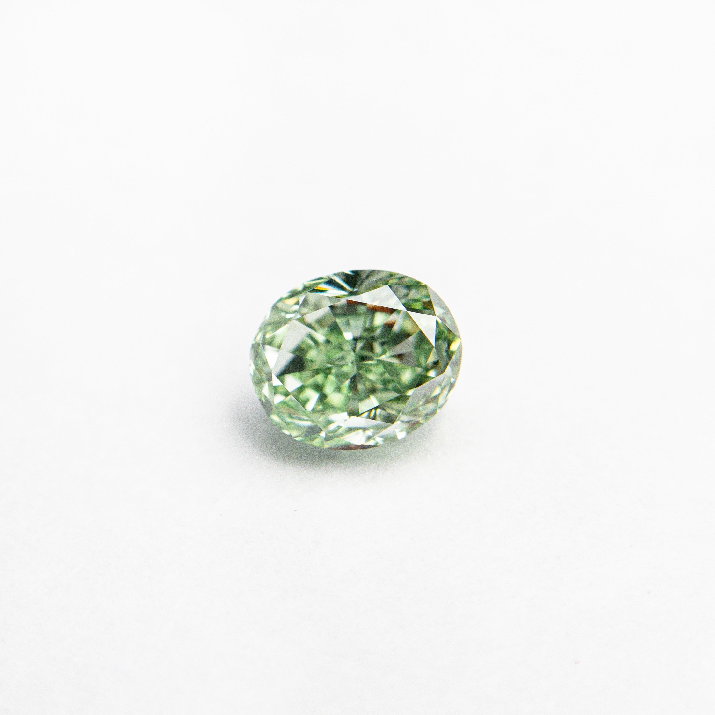 The 0.46ct 4.71x3.96x2.93mm GIA VS2 Fancy Vivid Green Oval Brilliant 24135-01 by East London jeweller Rachel Boston | Discover our collections of unique and timeless engagement rings, wedding rings, and modern fine jewellery.