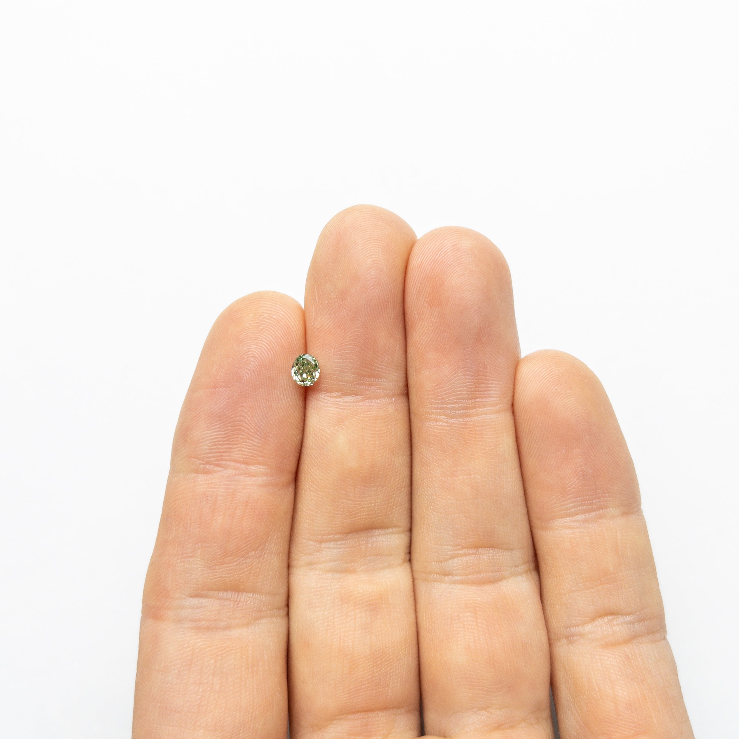 The 0.46ct 4.71x3.96x2.93mm GIA VS2 Fancy Vivid Green Oval Brilliant 24135-01 by East London jeweller Rachel Boston | Discover our collections of unique and timeless engagement rings, wedding rings, and modern fine jewellery.