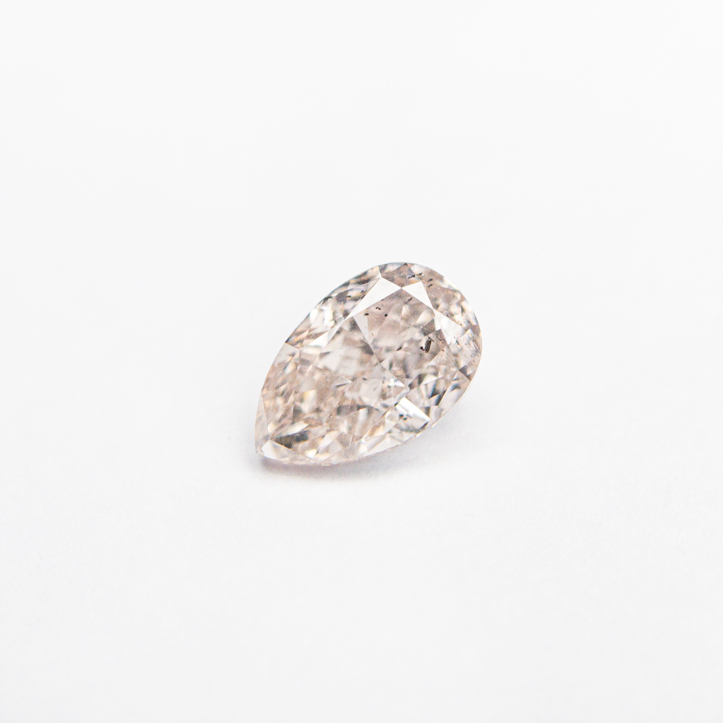 The 0.46ct 5.85x3.80x2.65mm SI2 Fancy Light Brownish Pink Pear Brilliant 🇦🇺 24118-01 by East London jeweller Rachel Boston | Discover our collections of unique and timeless engagement rings, wedding rings, and modern fine jewellery.