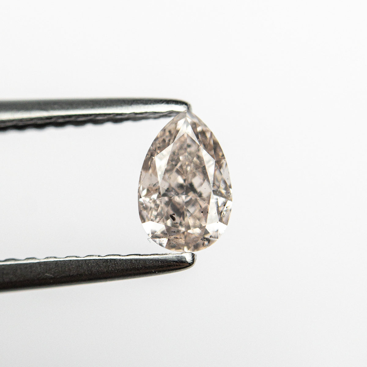 The 0.46ct 5.85x3.80x2.65mm SI2 Fancy Light Brownish Pink Pear Brilliant 🇦🇺 24118-01 by East London jeweller Rachel Boston | Discover our collections of unique and timeless engagement rings, wedding rings, and modern fine jewellery.