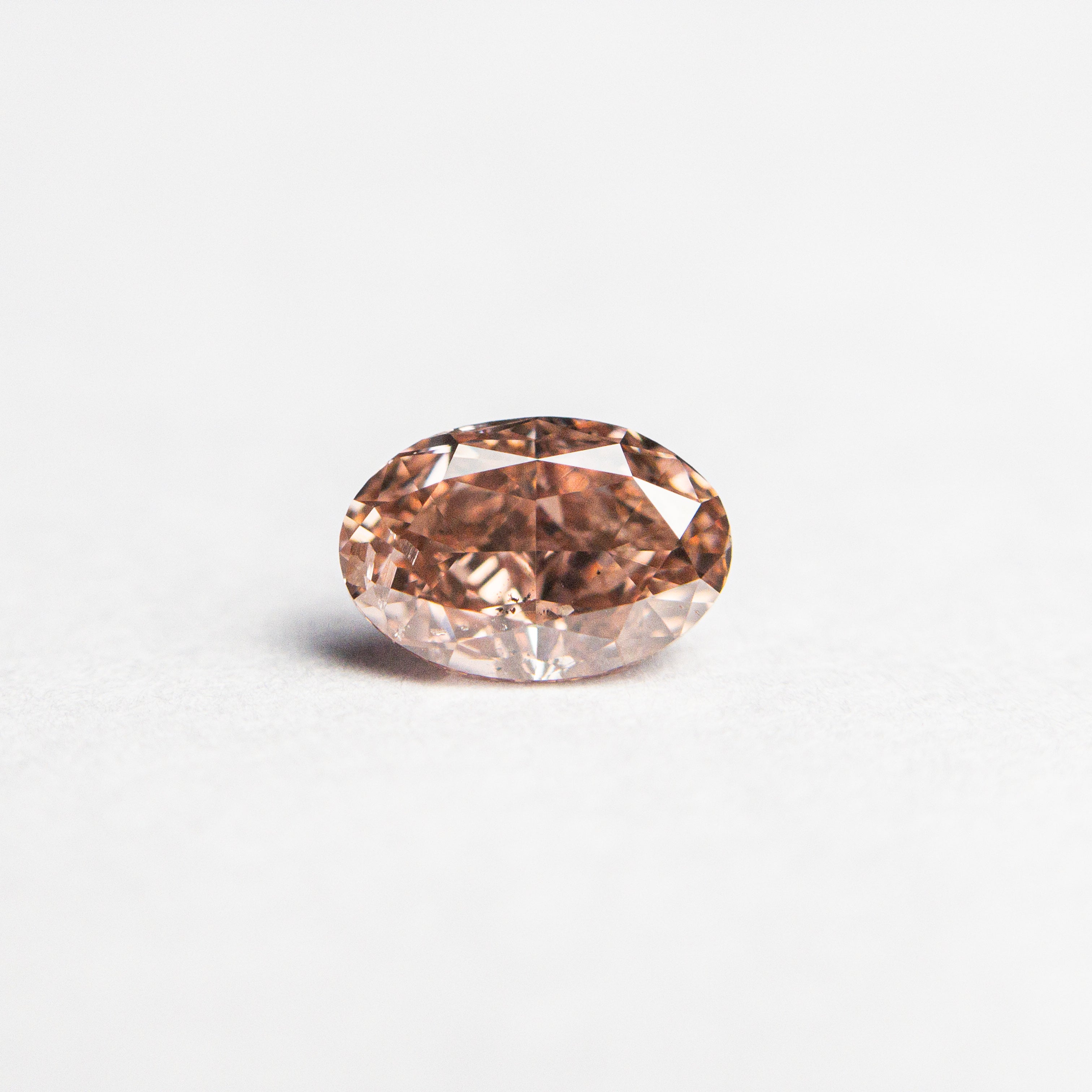 The 0.50ct 5.89x3.98x2.71mm GIA SI2 Fancy Deep Brownish Orangy Pink Oval Brilliant 🇦🇺 24163-01 by East London jeweller Rachel Boston | Discover our collections of unique and timeless engagement rings, wedding rings, and modern fine jewellery.