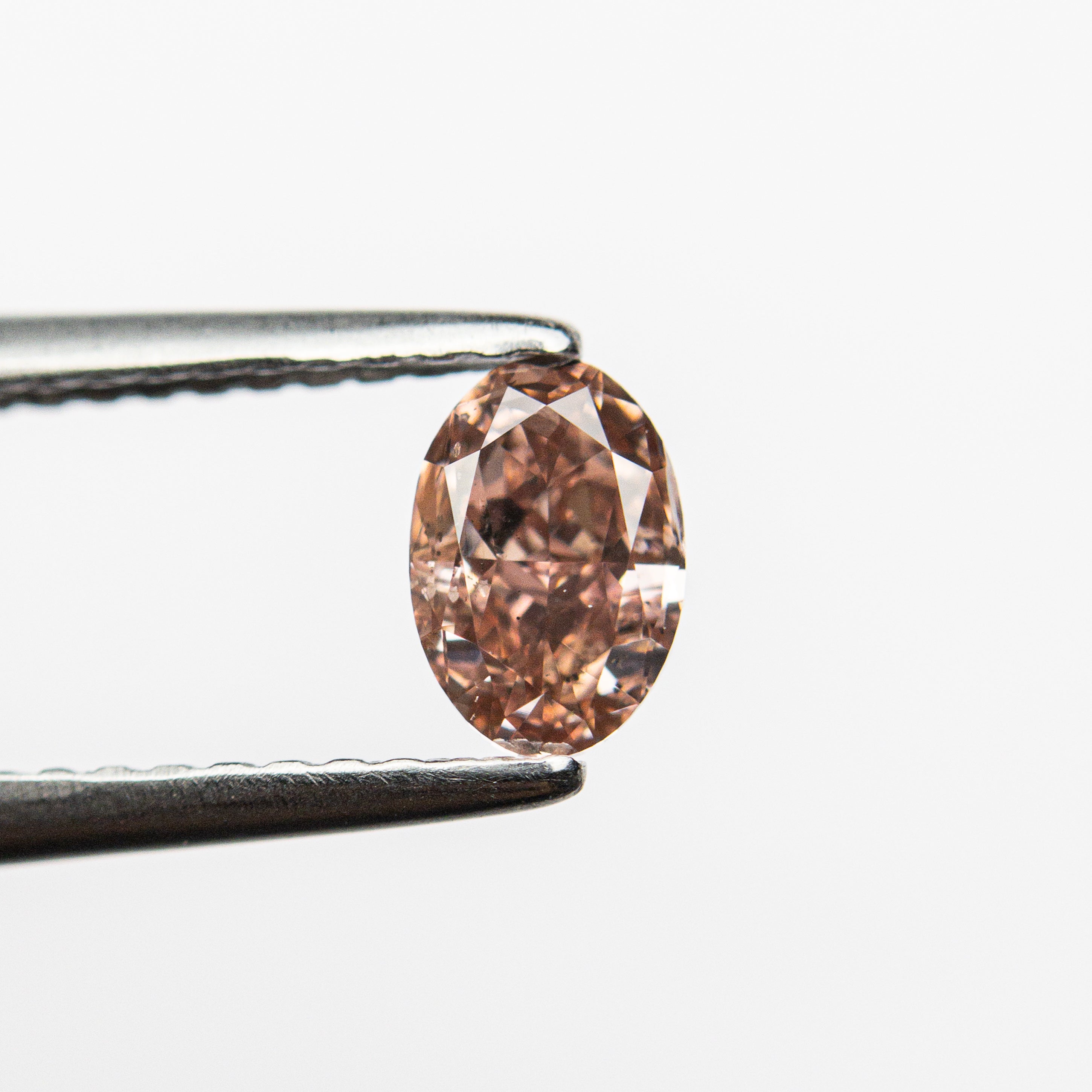The 0.50ct 5.89x3.98x2.71mm GIA SI2 Fancy Deep Brownish Orangy Pink Oval Brilliant 🇦🇺 24163-01 by East London jeweller Rachel Boston | Discover our collections of unique and timeless engagement rings, wedding rings, and modern fine jewellery.