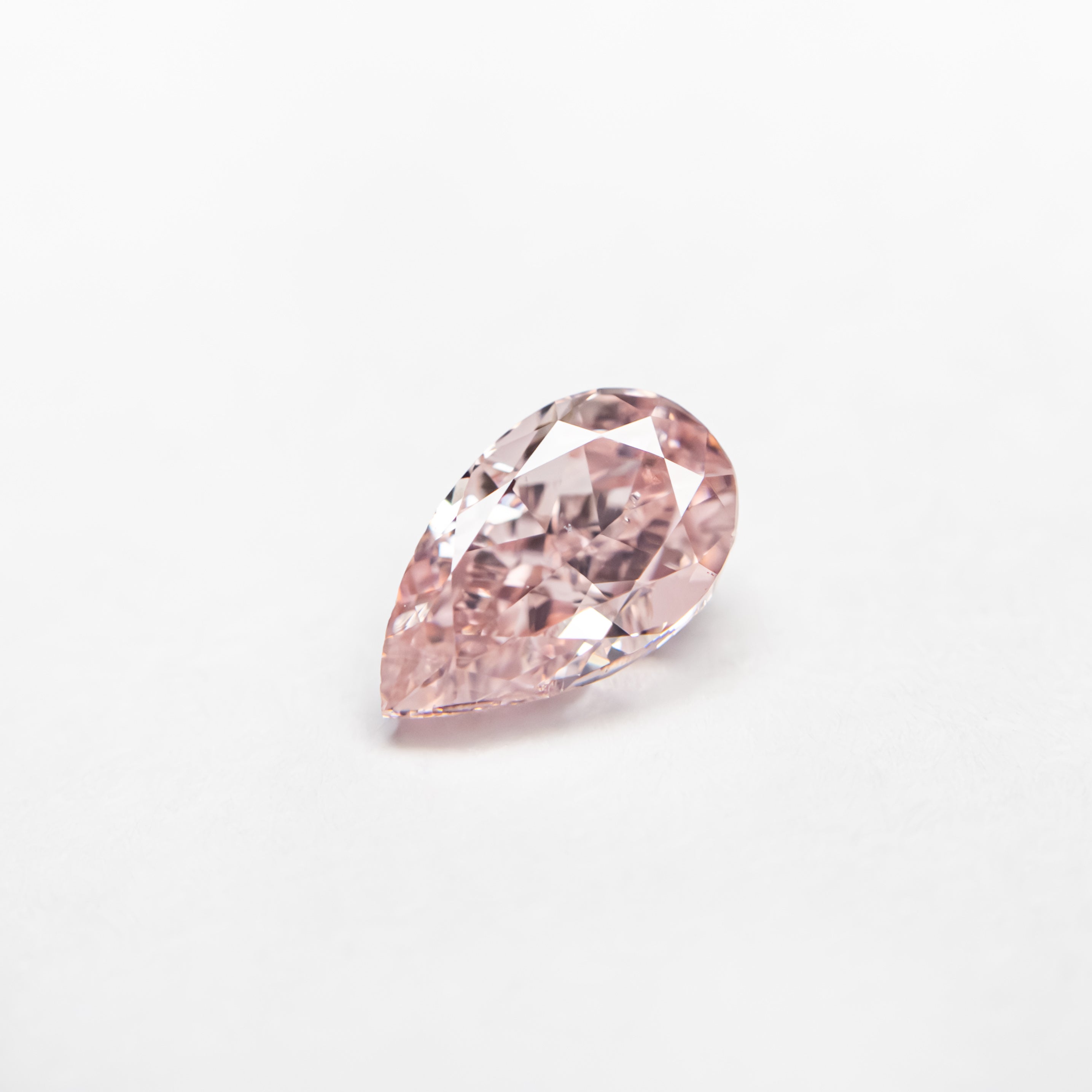 The 0.50ct 6.21x3.75x2.84mm GIA SI2 Fancy Orangy Pink Pear Brilliant 24130-01 by East London jeweller Rachel Boston | Discover our collections of unique and timeless engagement rings, wedding rings, and modern fine jewellery.