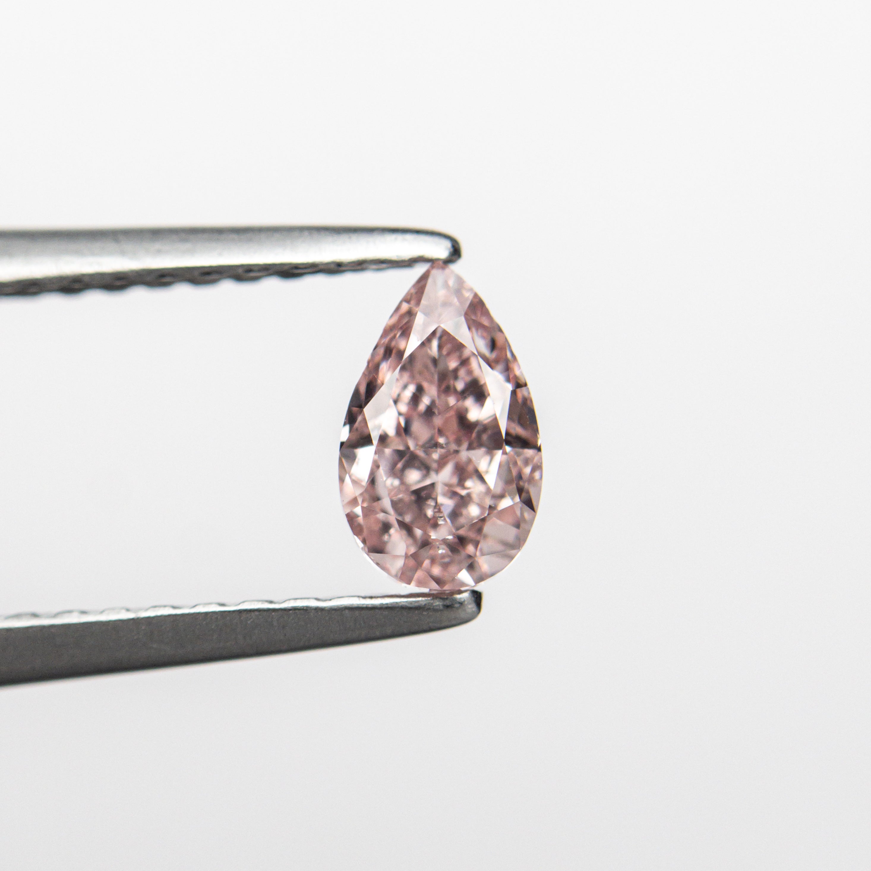 The 0.50ct 6.21x3.75x2.84mm GIA SI2 Fancy Orangy Pink Pear Brilliant 24130-01 by East London jeweller Rachel Boston | Discover our collections of unique and timeless engagement rings, wedding rings, and modern fine jewellery.