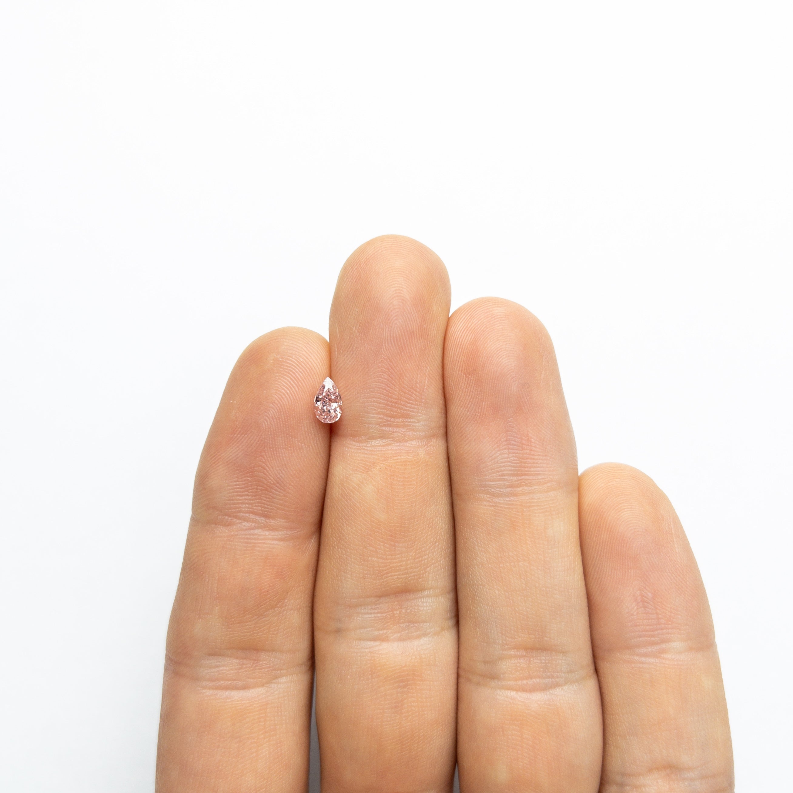 The 0.50ct 6.21x3.75x2.84mm GIA SI2 Fancy Orangy Pink Pear Brilliant 24130-01 by East London jeweller Rachel Boston | Discover our collections of unique and timeless engagement rings, wedding rings, and modern fine jewellery.