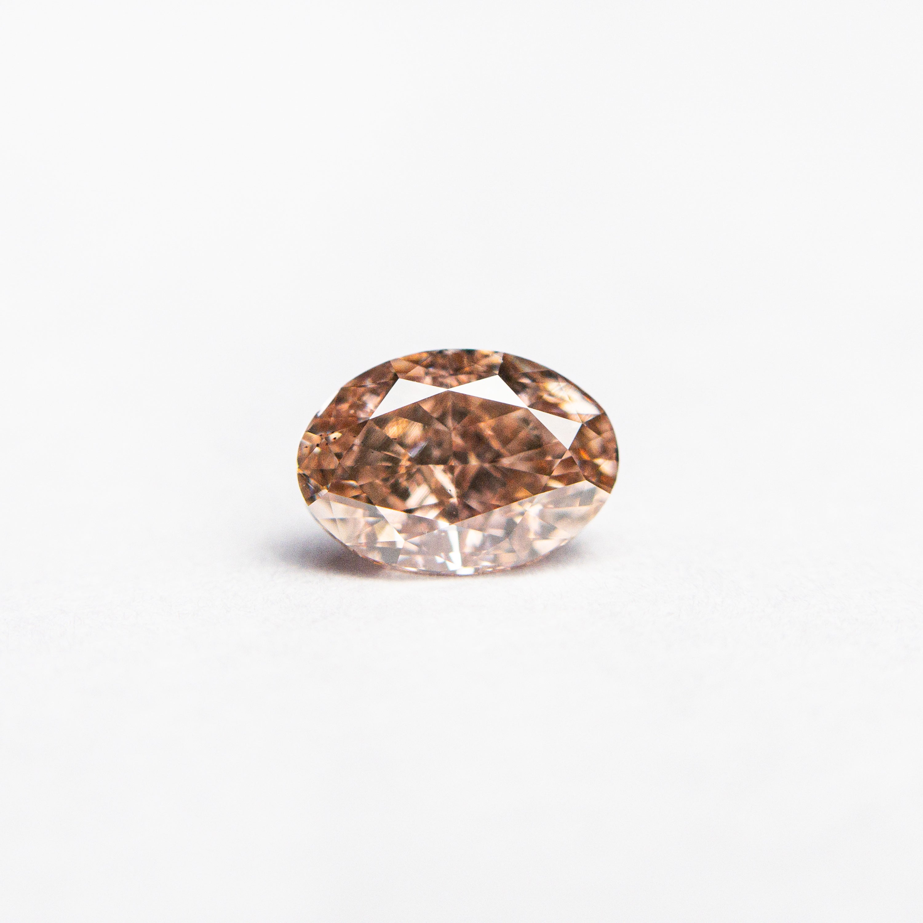 The 0.53ct 5.75x4.03x2.87mm GIA VS2 Fancy Brownish Orangy Pink Oval Brilliant 🇦🇺 24158-01 by East London jeweller Rachel Boston | Discover our collections of unique and timeless engagement rings, wedding rings, and modern fine jewellery.