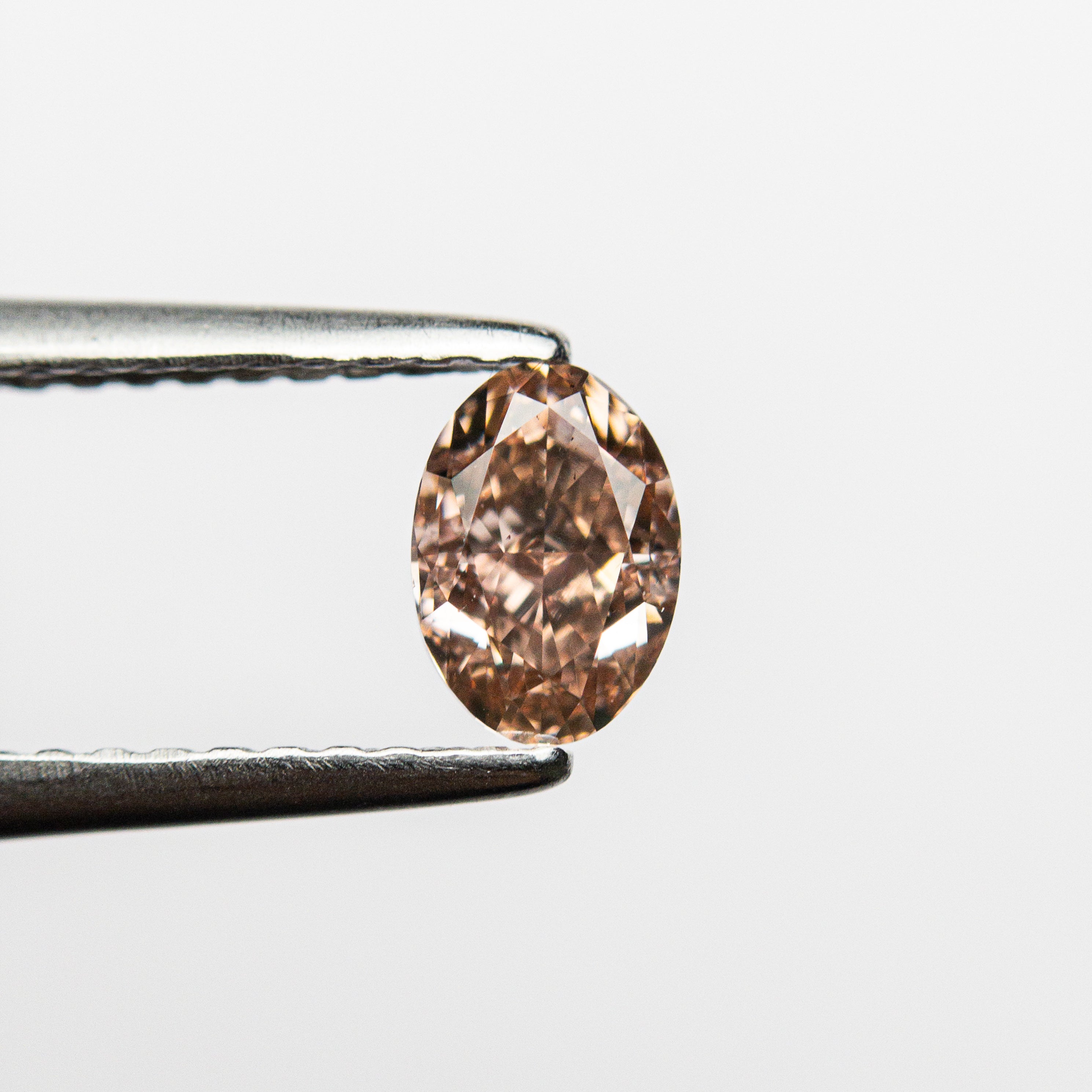 The 0.53ct 5.75x4.03x2.87mm GIA VS2 Fancy Brownish Orangy Pink Oval Brilliant 🇦🇺 24158-01 by East London jeweller Rachel Boston | Discover our collections of unique and timeless engagement rings, wedding rings, and modern fine jewellery.